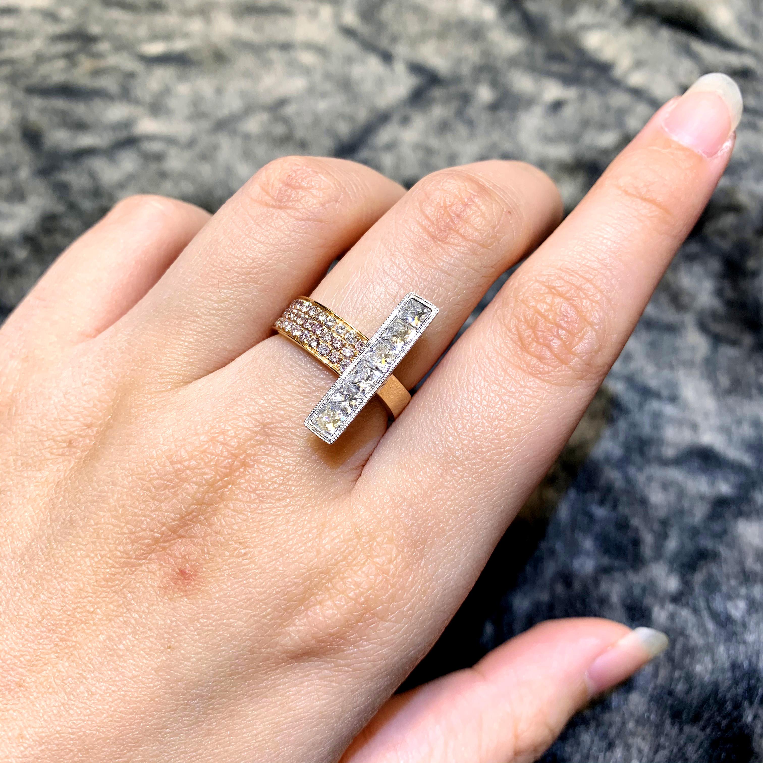 Normally in a band ring, diamonds are set horizontally. But in this ring the diamonds are set vertically with natural fancy pink diamond from Australia. We have used 1.21 carat of white brilliant princess cut diamond. The color is F and clarity is
