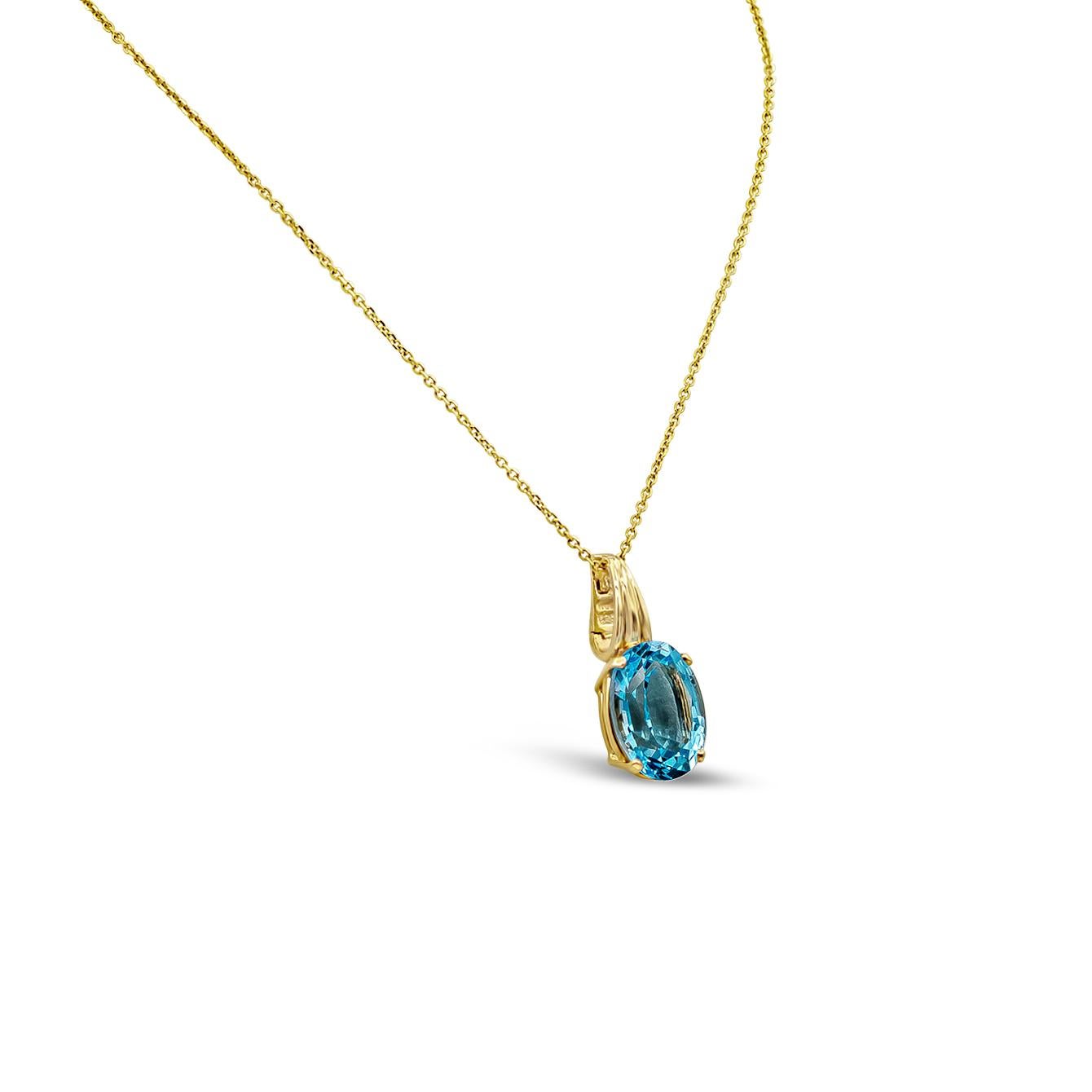 A simple yet timeless pendant necklace showcasing a color rich blue oval cut topaz, set in an 18k yellow gold mounting. Topaz weighs 12.10 carats. Suspended on an 18 inch yellow gold chain. 