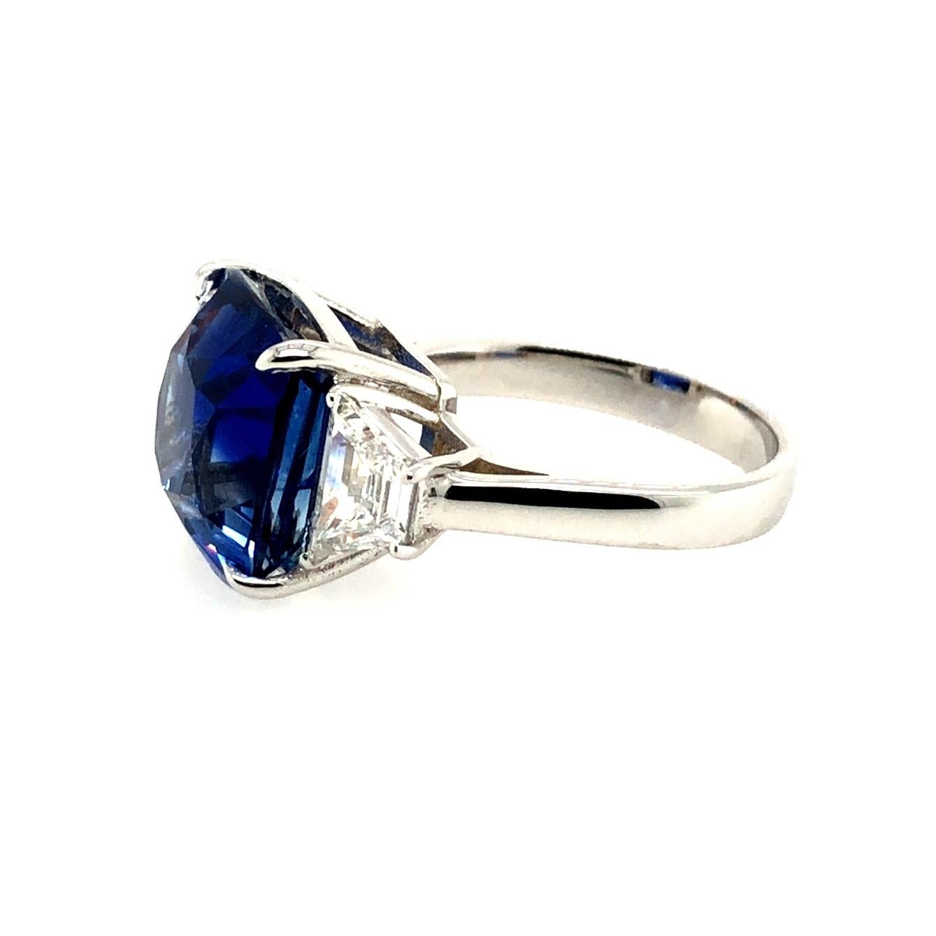 Offered here is an absolutely gorgeous 12.10 carat certified natural NO HEAT sapphire from Madagascar set in a white gold 18k ring with 2 trapezoid diamonds. The sapphire is a square cushion cut with a vivid blue color and measures 12.09 x 11.99