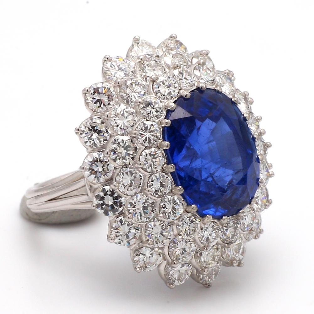 Vibrant blue 12.10ct sapphire featured in this platinum ring
The origin is burma, no heat.  AGL certified
4.35ctw of collection quality diamonds around the sapphire

Sizable to any finger size