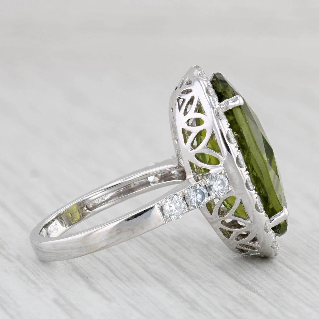 Gemstone Information:
- Natural Peridot -
Carats - 10.97ct 
Cut - Faceted Oval
Color - Light Green

- Natural Diamonds -
Total Carats - 1.13ctw
Cut - Round Brilliant
Color - F - G
Clarity - I1- I2

Metal: 18k White Gold
Weight: 9.1 Grams 
Stamps: