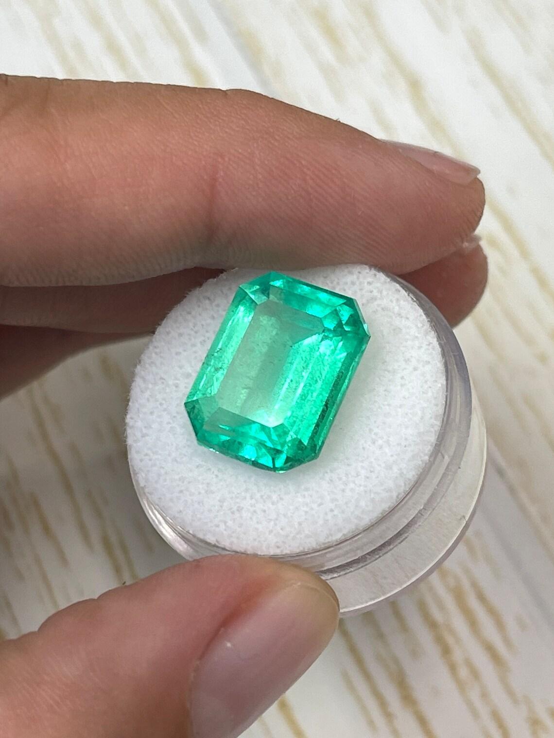 Stone: Emerald
Weight: 12.11-carats
Shape: Emerald Cut
Clarity: Transparent
Luster: Excellent-Very Good
Color: Yellowish Green
Measurements: 16.04mm x 12.32mm x 8.52mm
Geographic Origin: Colombia
Treatment: Natural, F2 Oiling

Comments: Due to their