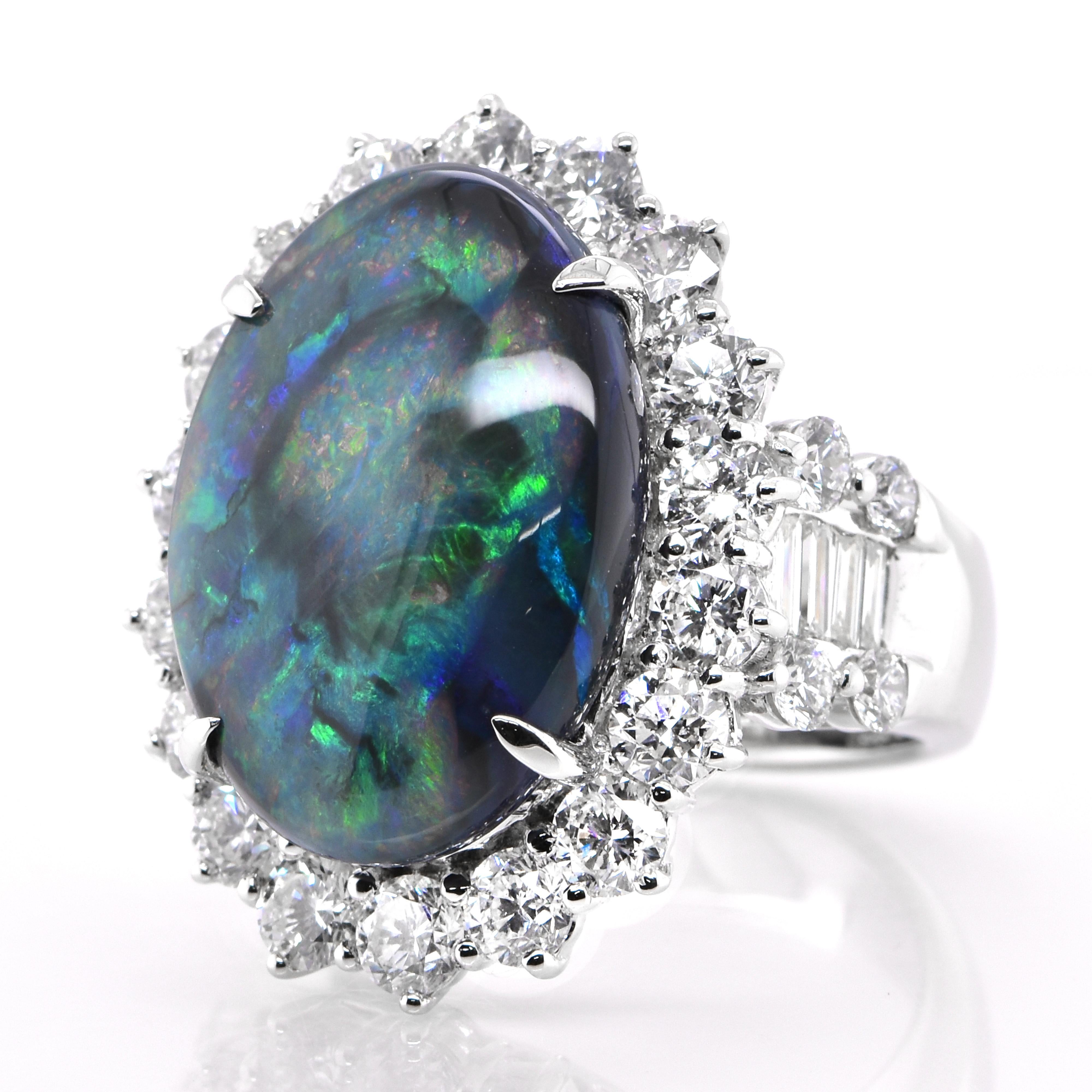 A beautiful ring featuring a 12.13 Carat, Natural, Australian Black Opal and 4.23 Carats of Diamond Accents set in Platinum. The Opal displays very good play of color! Opals are known for exhibiting flashes of rainbow colors known as 