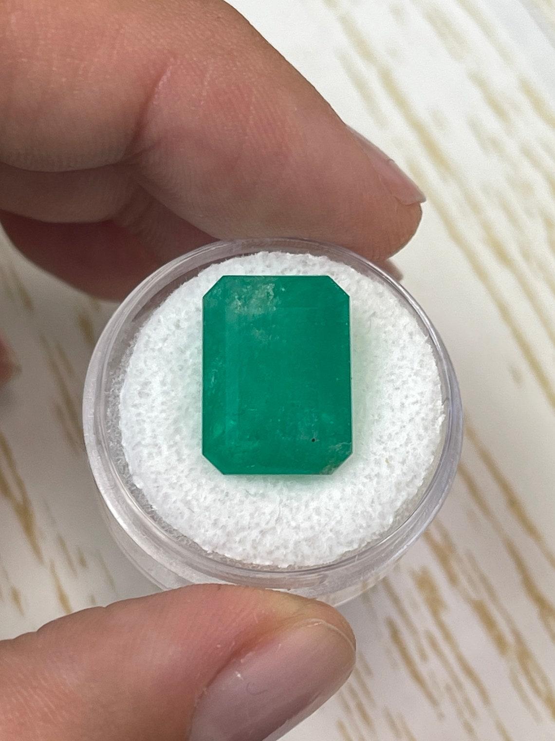 Stone: Emerald
Weight: 12.13-carats
Shape: Emerald Cut
Clarity: Semi-Transparent
Luster: Very Good
Color: Medium Green
Measurements: 15.39mm x 11.54mm x 9.91mm
Geographic Origin: Colombia
Treatment: Natural, Oiling

Comments: Due to their growth