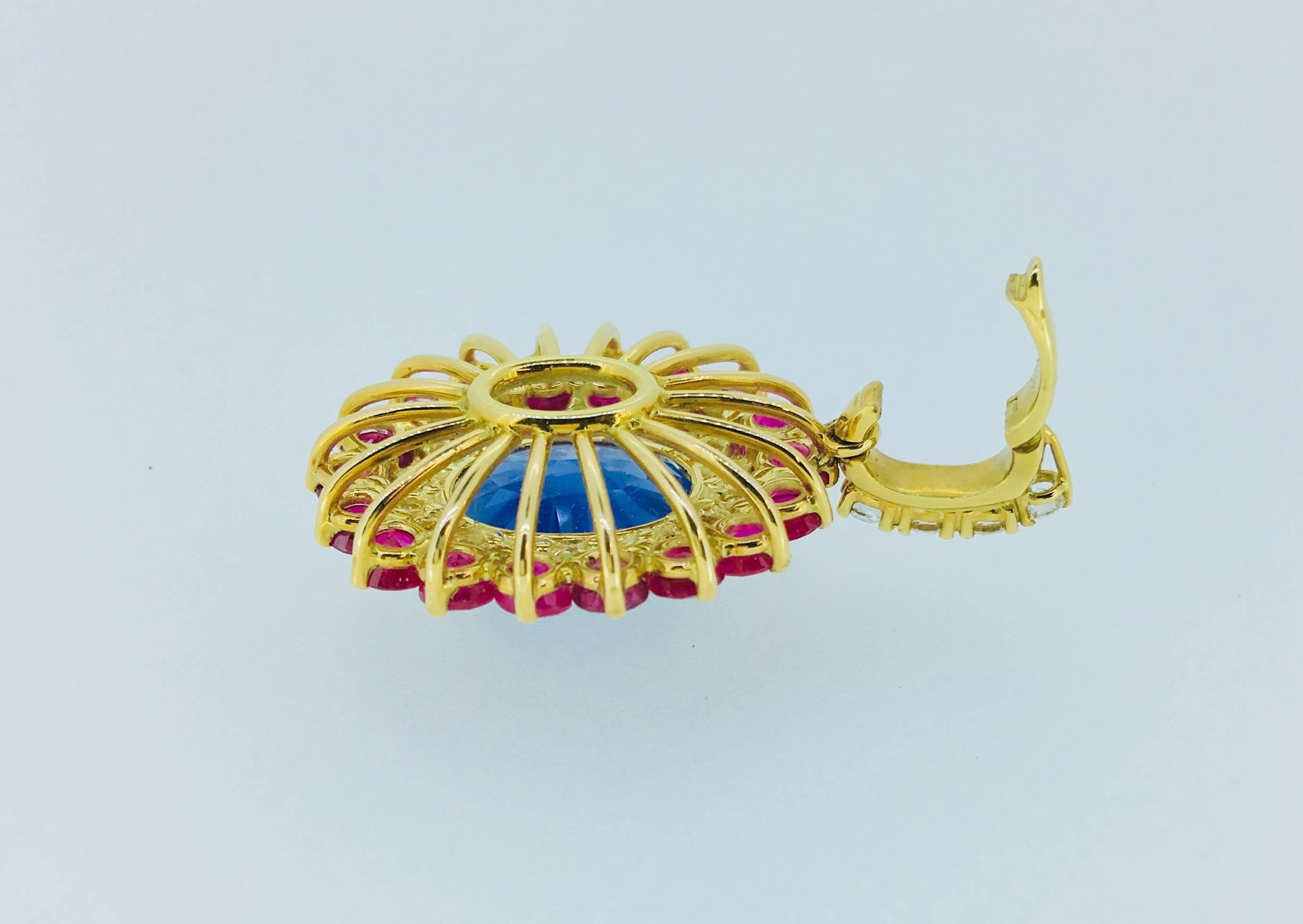 Handmade Pendant with a oval Ceylon-Sapphire, 12.14 Carat, 
surroundend by Diamonds, 1.79 Carat, TW/vvs-vs and
Burma-Rubies, 5.98 ct.,
18 Karat Yellow Gold