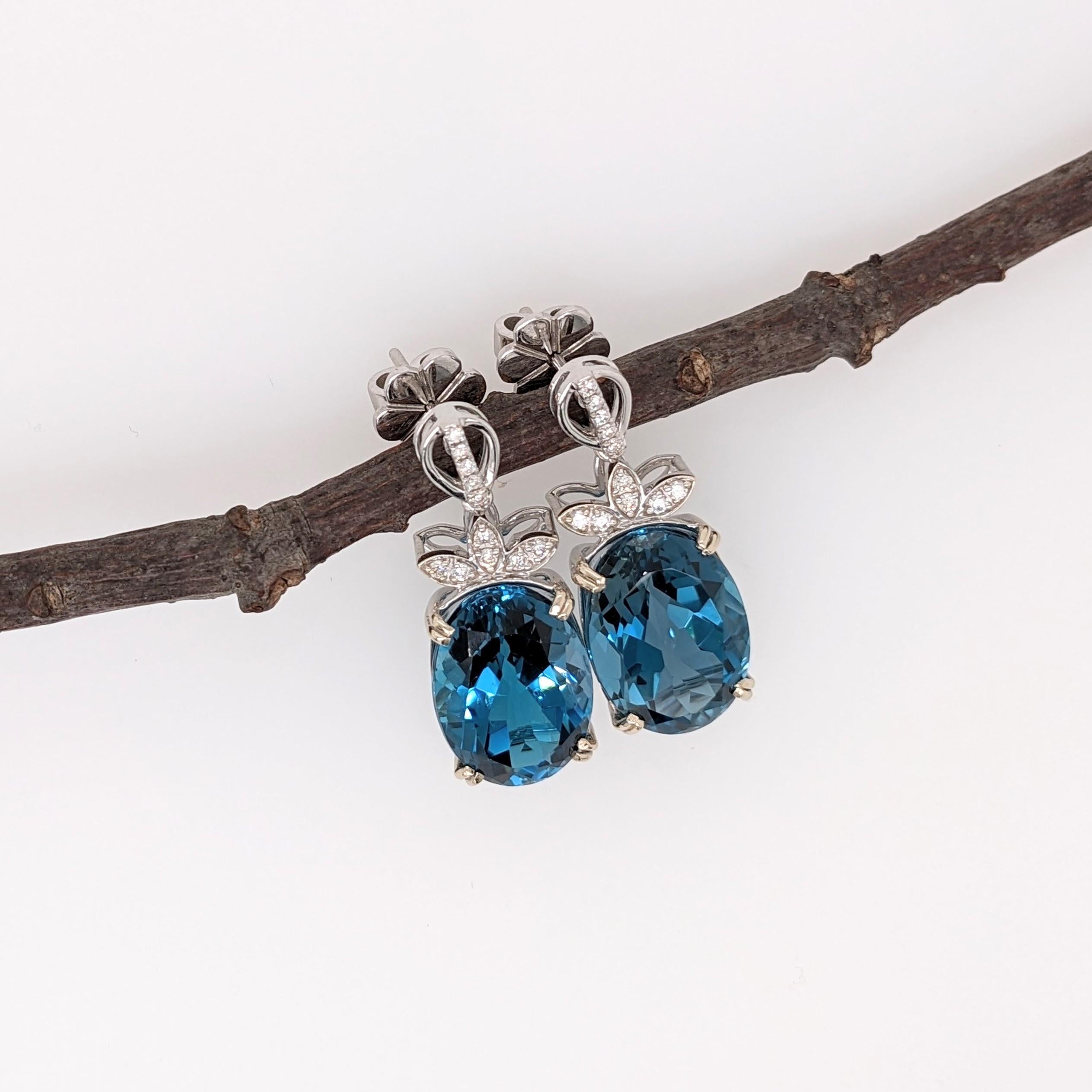 These beautiful drop earrings feature a pair of 12.14 carat weight london topaz gemstones with natural earth mined diamonds, all set in solid 14K gold. These earrings can be a beautiful December birthstone gift for your loved ones!