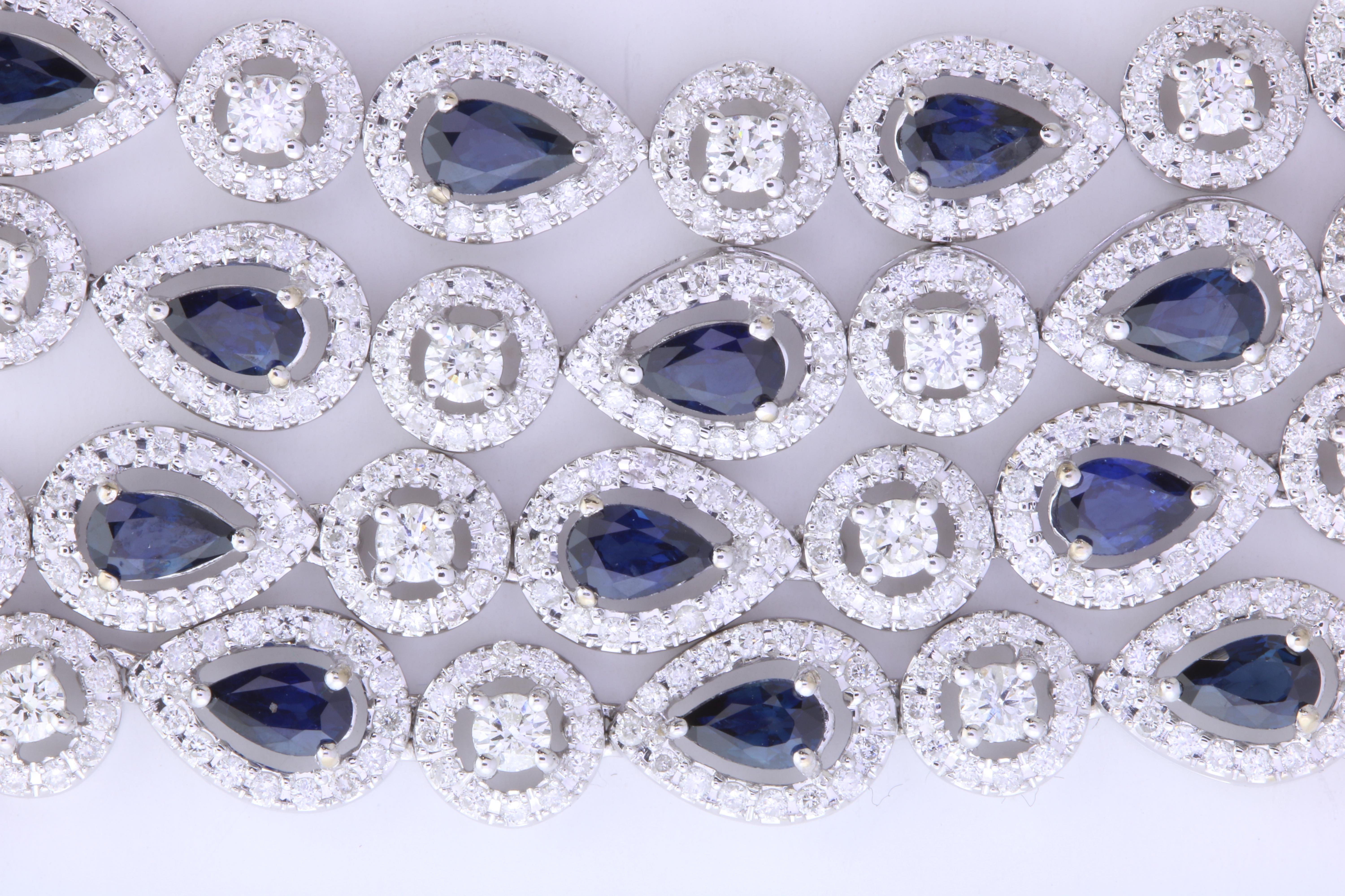 Material: 18k White Gold 
Stone Details: 53 Pear Shaped Blue Sapphires at 12.18 Carats 
Diamonds:  1537 Round Diamonds at 9.64 Carats.  SI Quality /  H-I Color
Length: 32 Inches

Fine one-of-a-kind craftsmanship meets incredible quality in this