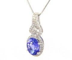 1.21ct Oval Tanzanite and 0.35ctw Diamond Accent Halo Pendant Necklace in 14K