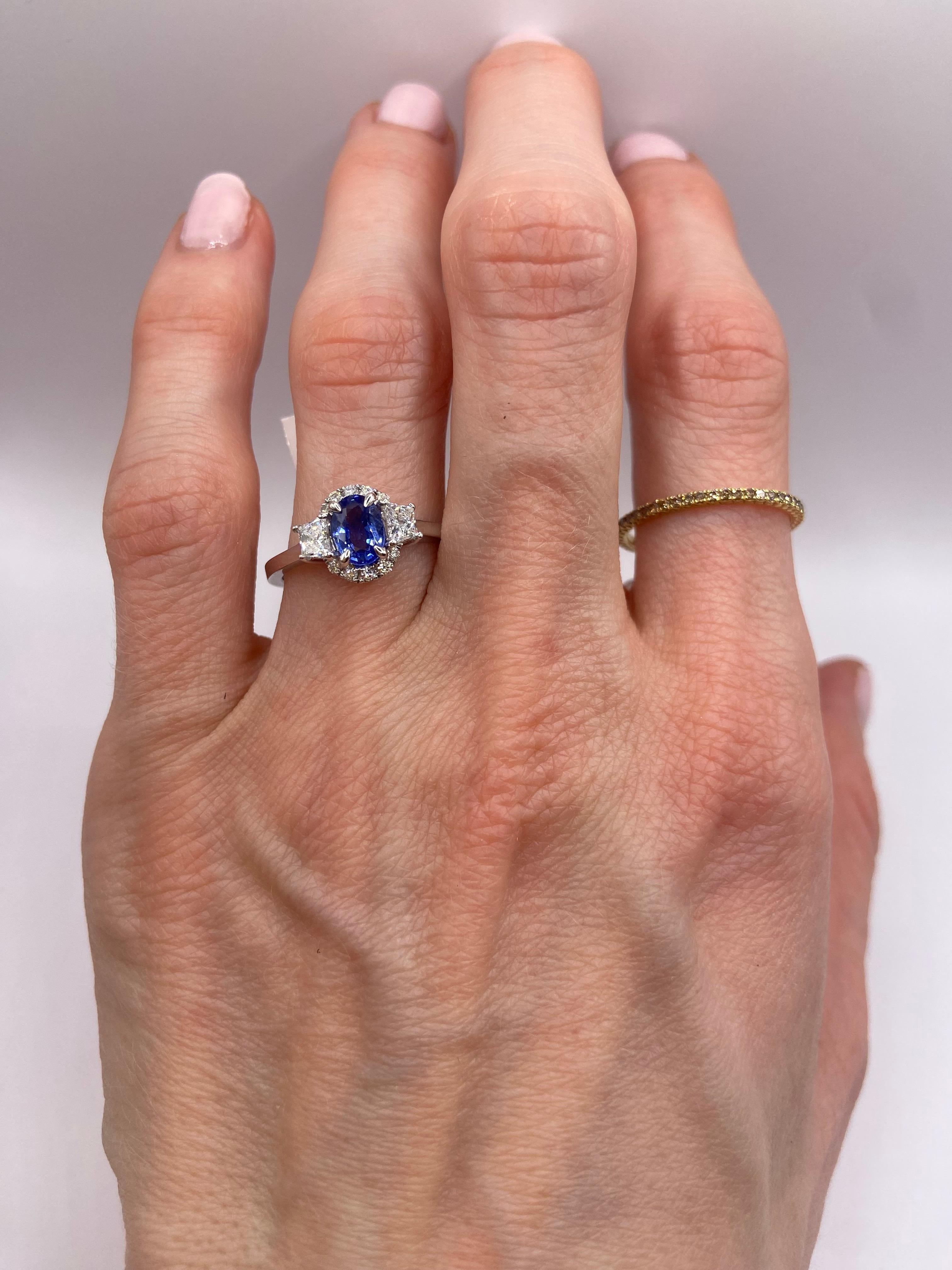 Metal: 18KT White Gold
Size: 6.5
(Ring is size 6.5 but is sizable upon request)

Number of Oval Sapphires: 1
Carat Weight: 0.78ctw
Stone Size: 6.5 x 4.5mm

Number of Trapezoid Diamonds: 2
Carat Weight: 0.35ctw

Number of Round Diamonds: 10
Carat