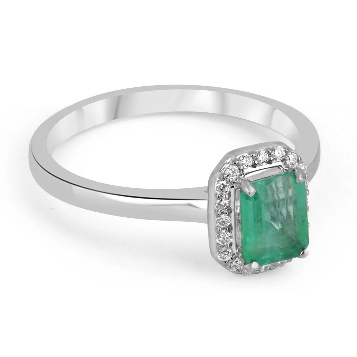 A simple, yet so beautiful emerald and diamond engagement/right-hand ring. The center stone features a stunning 1.09-carat, natural Zambian emerald with a medium bluish-green color and good eye clarity. Surrounding the center gem are various petite
