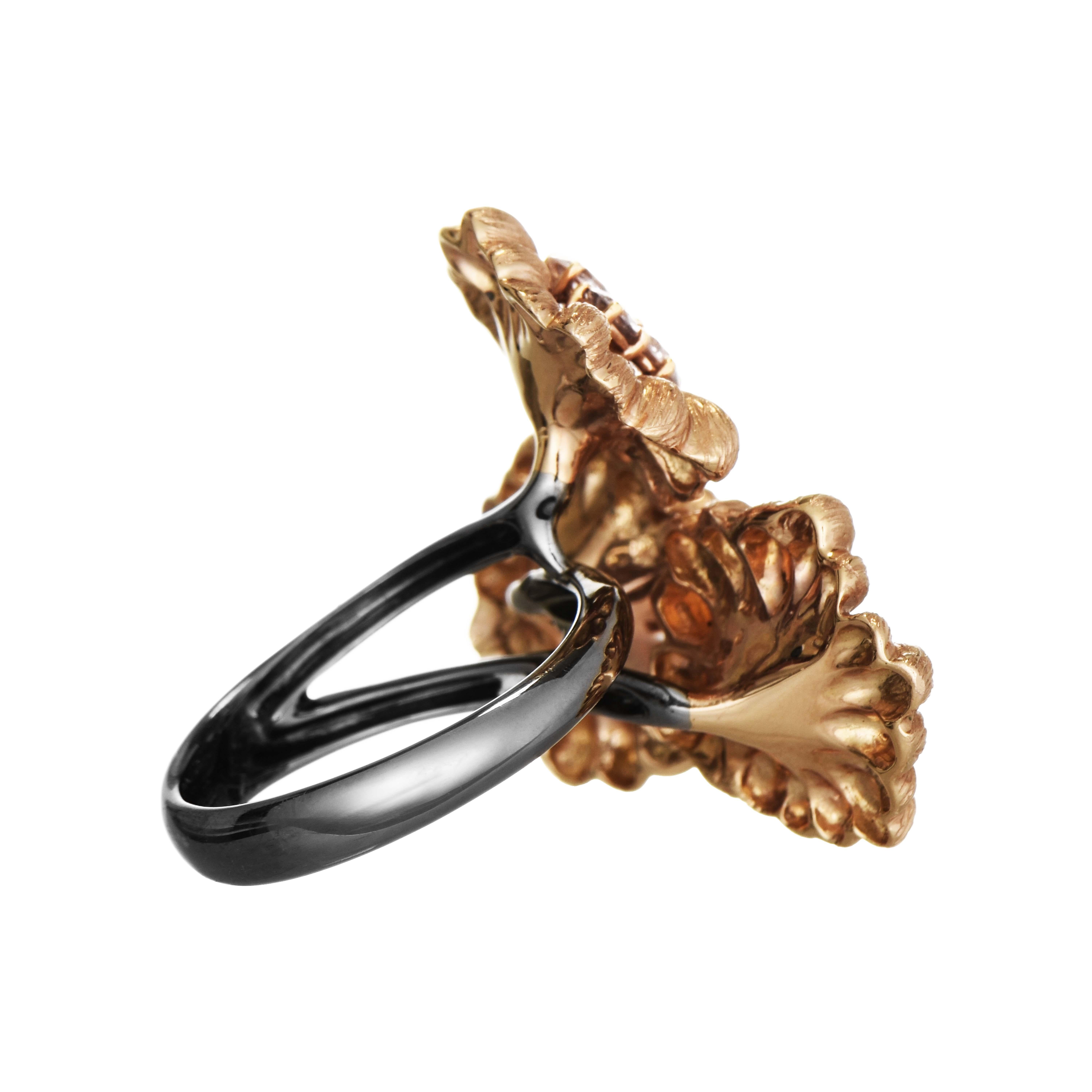 This beautiful floral ring features a trio of rose gold flowers, two of which are adorned with 3 diamonds and one with 1 diamond, all set in a black gold bypass band.

7 White Diamonds: 1.22 Carats, Round Cut
Metal: 18K Rose and Black Gold, 28.10