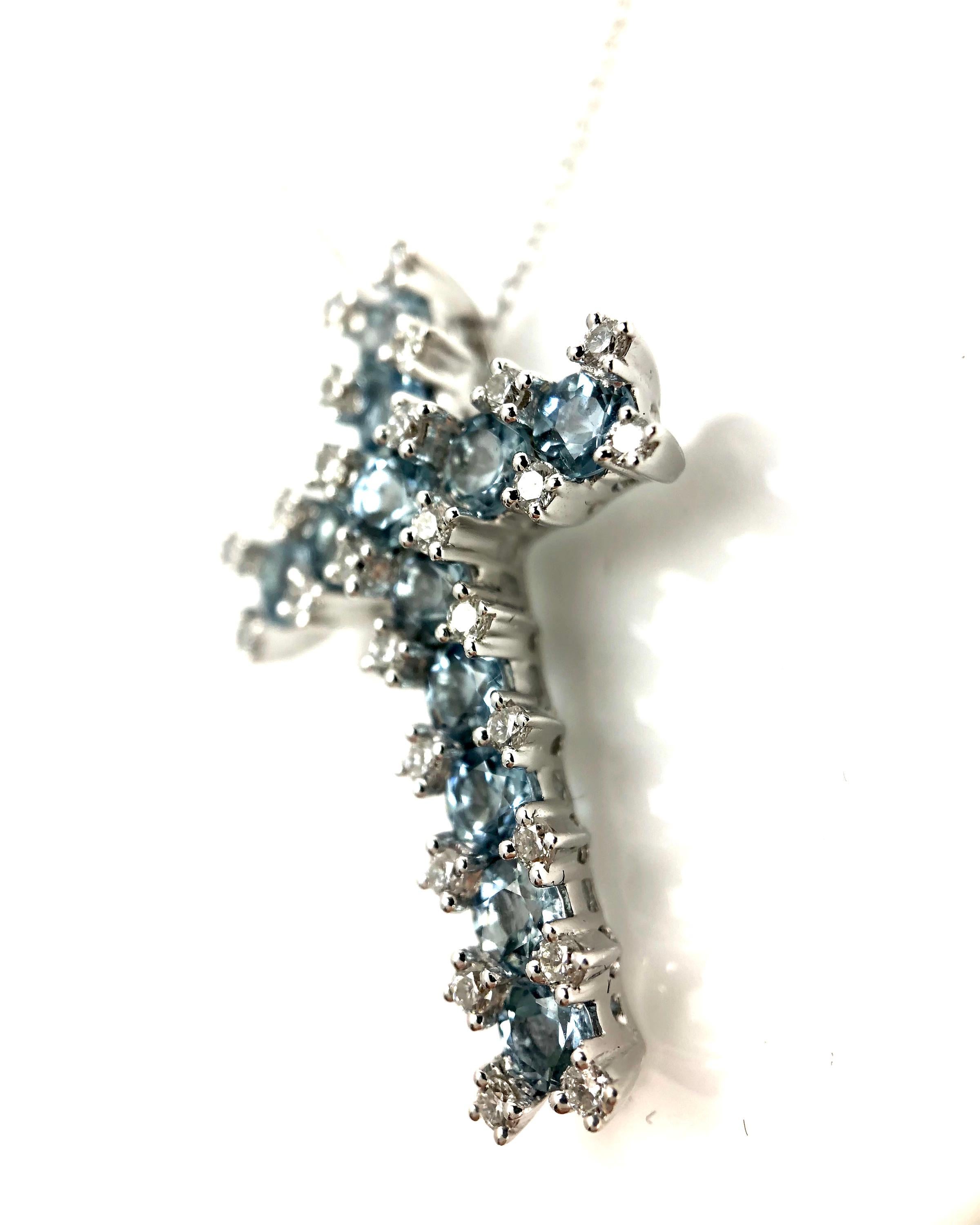 This lovely cross pendant features 1.22 carats round cut Aquamarine, set among 0.29 carats round white diamonds.

1.22 carats Aquamarine, 12 stones
26 round diamonds total 0.29 carats
Set in 18k White Gold.

Many of our items have matching companion