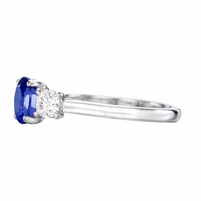  wonderful royal blue hue that is well saturated. It is an impressive gemstone that adds a beautiful pop of color to this classic three stone diamond ring