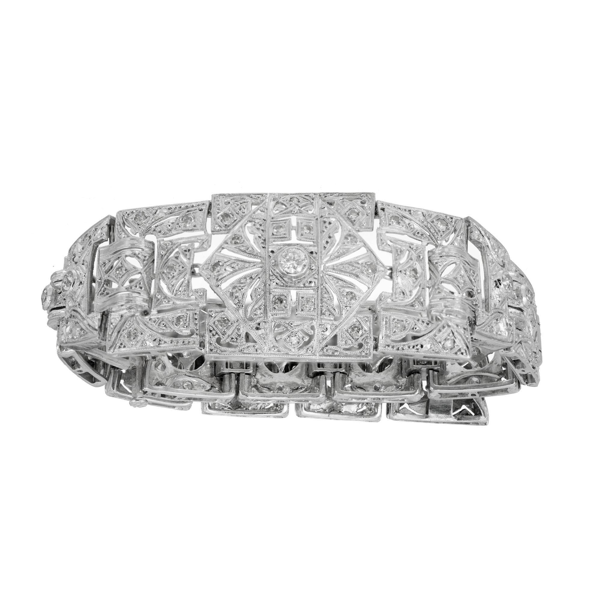 1920's Art Deco hinged link Platinum diamond bracelet. 63 round hand bead set diamonds set in platinum with pierced tops. Circa 1920's. 7.75 inches in length. 

1 brilliant cut diamond, approx. total weight .11cts. 
62 transitional single cut