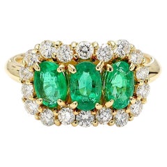 1.22 Carat Emerald
Diamond 18K Gold Halo Three Stone Band Ring
