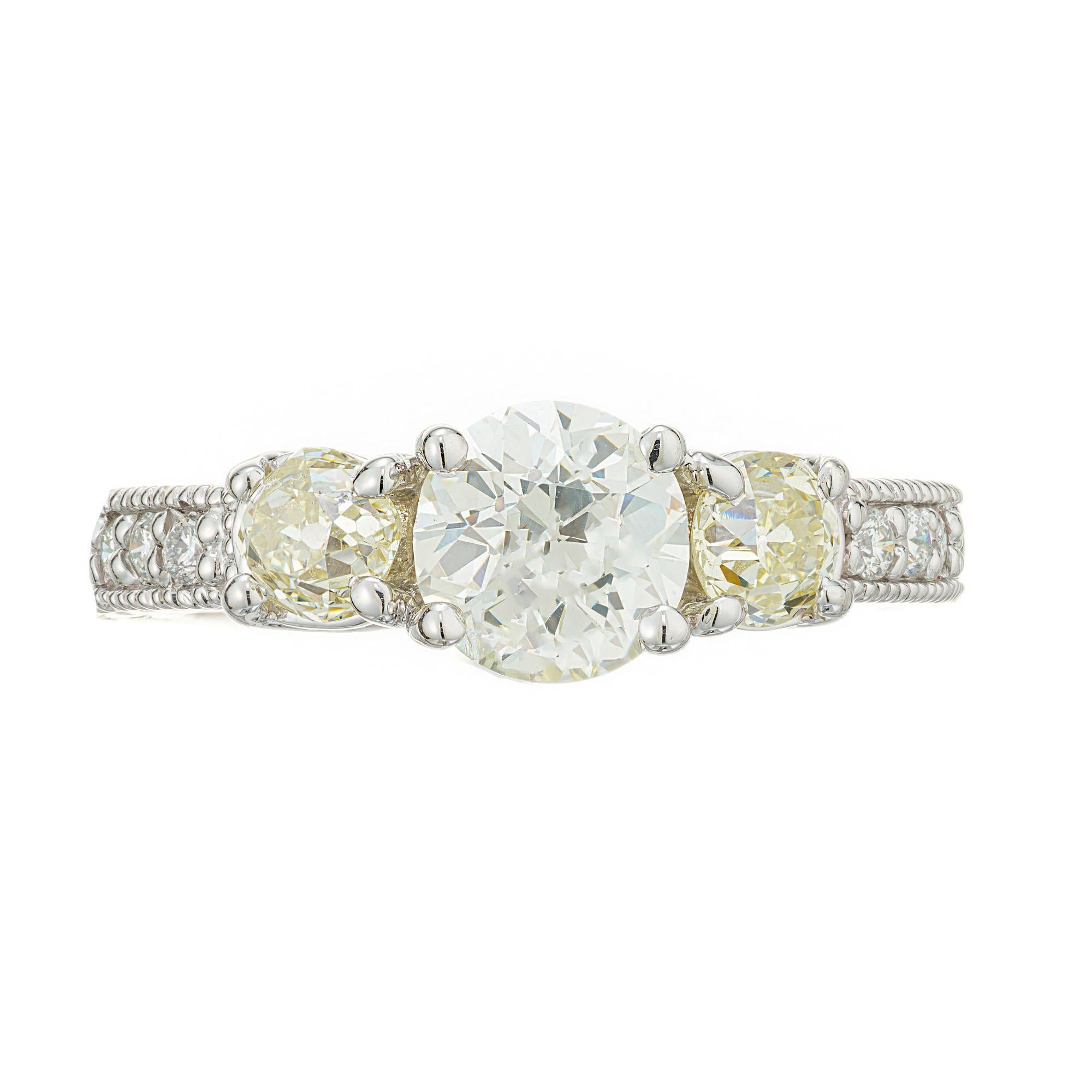 Diamond engagement ring. EGL Old European cut center diamond with 2 old European cut light yellow side diamonds in a 14k white gold Lucinda cross prong style setting with engraved sides and 6 diamond bead set on each side. Raised crowns and small