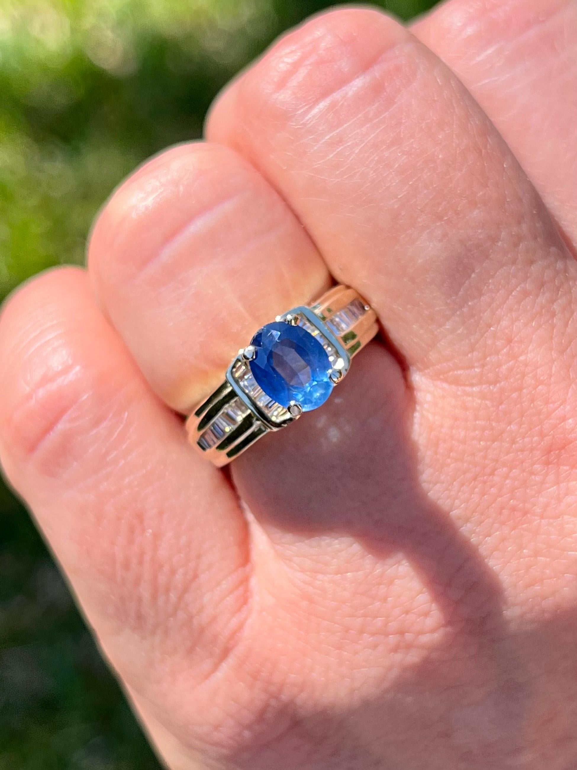 1.22-carat oval cut Blue Sapphire set with baguette-cut diamond accents in a 14k yellow gold ring. The baguette-cut diamond side stones serve as the perfect contrast to the light Blue Sapphire center stone. 

Polished finish for a long-lasting