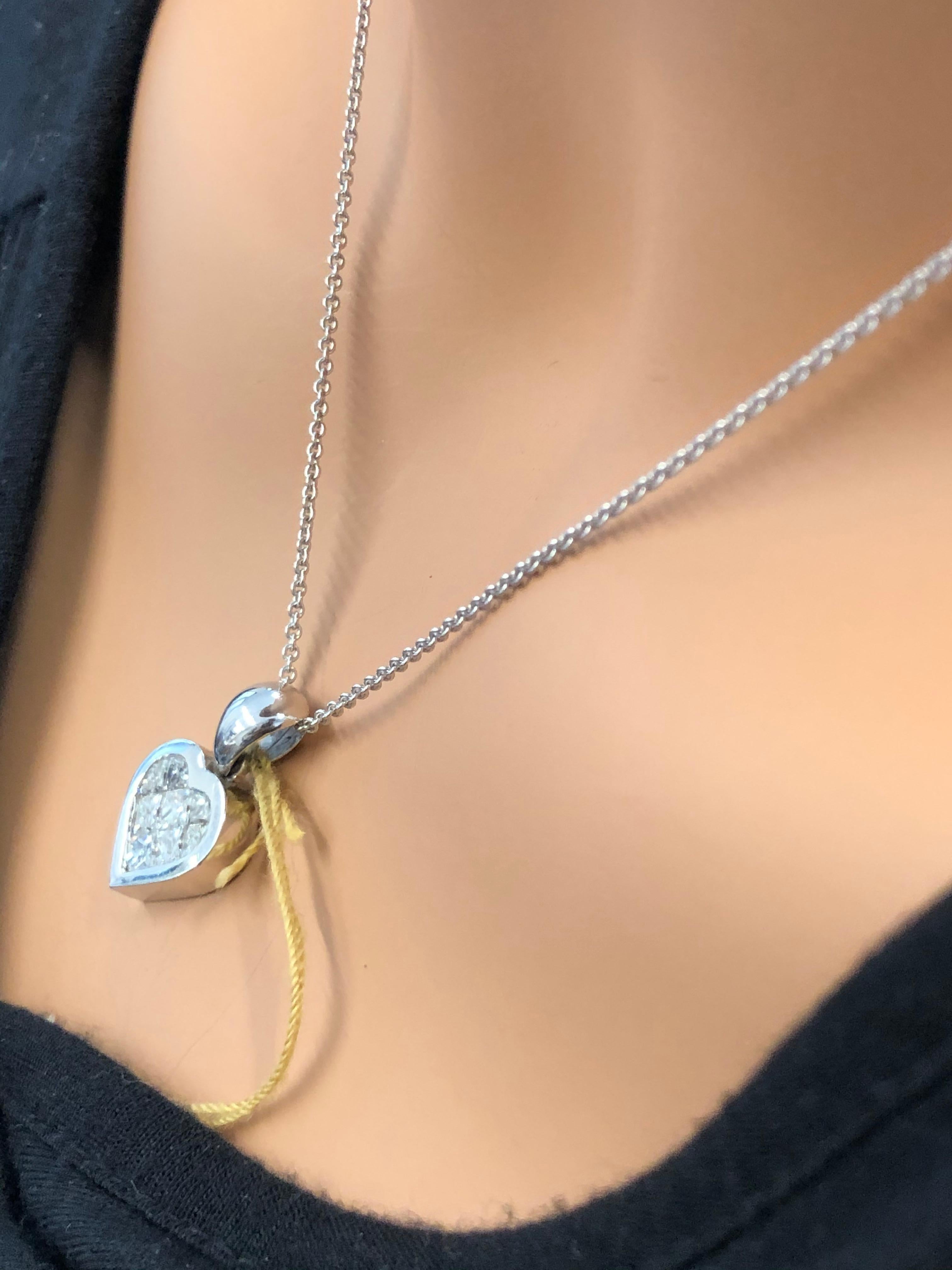 Designed in brightly polished 18 karat white gold, this beautiful diamond heart pendant features a total of 1.22 carats of invisibly channel set diamonds sparkling in the center. This gorgeous heart gracefully hangs from a tapered bail that awaits
