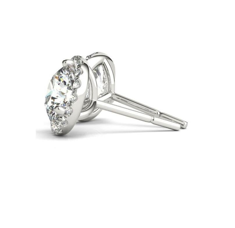 For sale are ladies diamond halo stud earrings mounted in 14KT white gold. These earrings features  1.00CTW Center diamonds (0.50CT diamond in each earring) F-G Color SI1 Clarity with 0.22CT of round Brilliant cut diamonds around the halo  E-F Color
