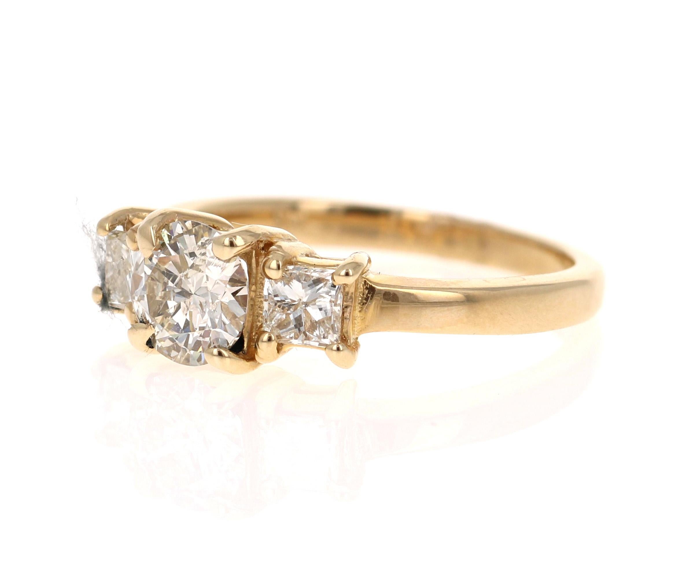 A classic and sparkly 3-stone Diamond ring set in 14 Karat Yellow Gold.

There is a Round Cut Diamond in the center which weighs 0.76 Carats and it has 2 Princess Cut Diamonds that weighs 0.46 Carats. The total Carat Weight of the ring is 1.22