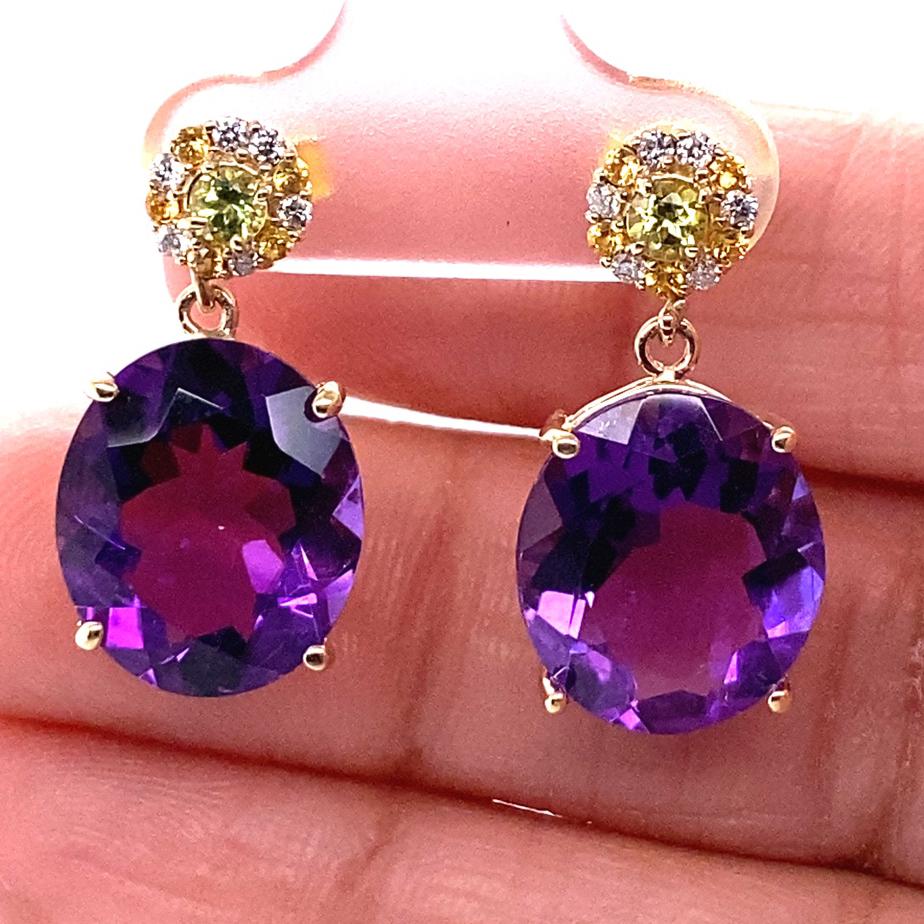 Amethyst, Yellow Sapphire and Diamond Drop Earrings! 

These stunning Earrings have 2 large Oval Cut Amethysts that weigh 11.68 Carats and are embellished with 22 Round Cut Diamonds (0.13 carats) and Yellow Sapphires (0.16 carats) that weigh 0.29