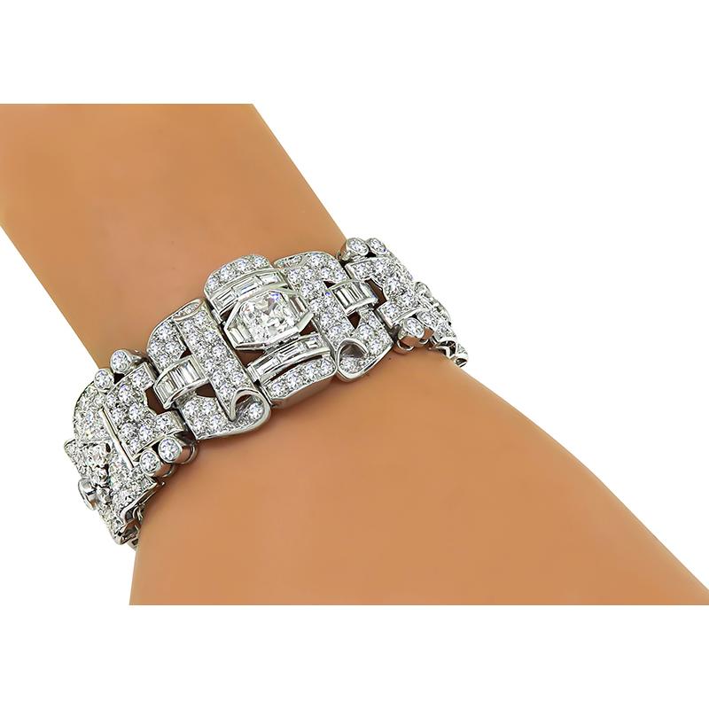 This is a stunning platinum bracelet. The bracelet is centered with a sparkling asscher cut diamond that weighs approximately 1.70ct. The color of the diamond is I with SI1 clarity. The center diamond is accentuated by dazzling baguette, trapezoid,