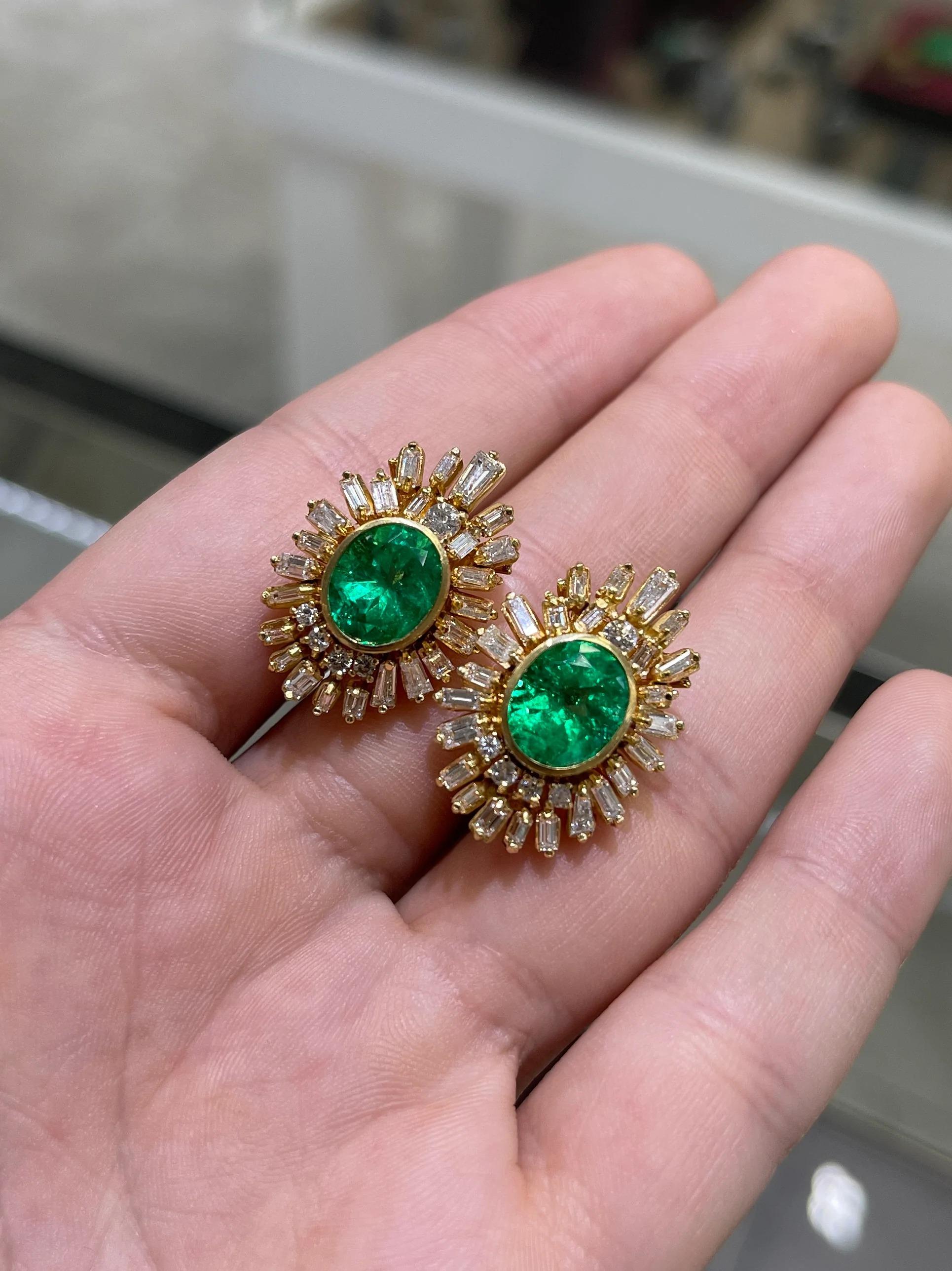 One-of-a-kind, bespoke, Colombian emerald & Diamond Omega stud earrings. These impressive earrings feature, fine quality, natural oval emeralds that are bezel set in 18K yellow gold. The emeralds showcase an incandescent vibrancy and simply glow