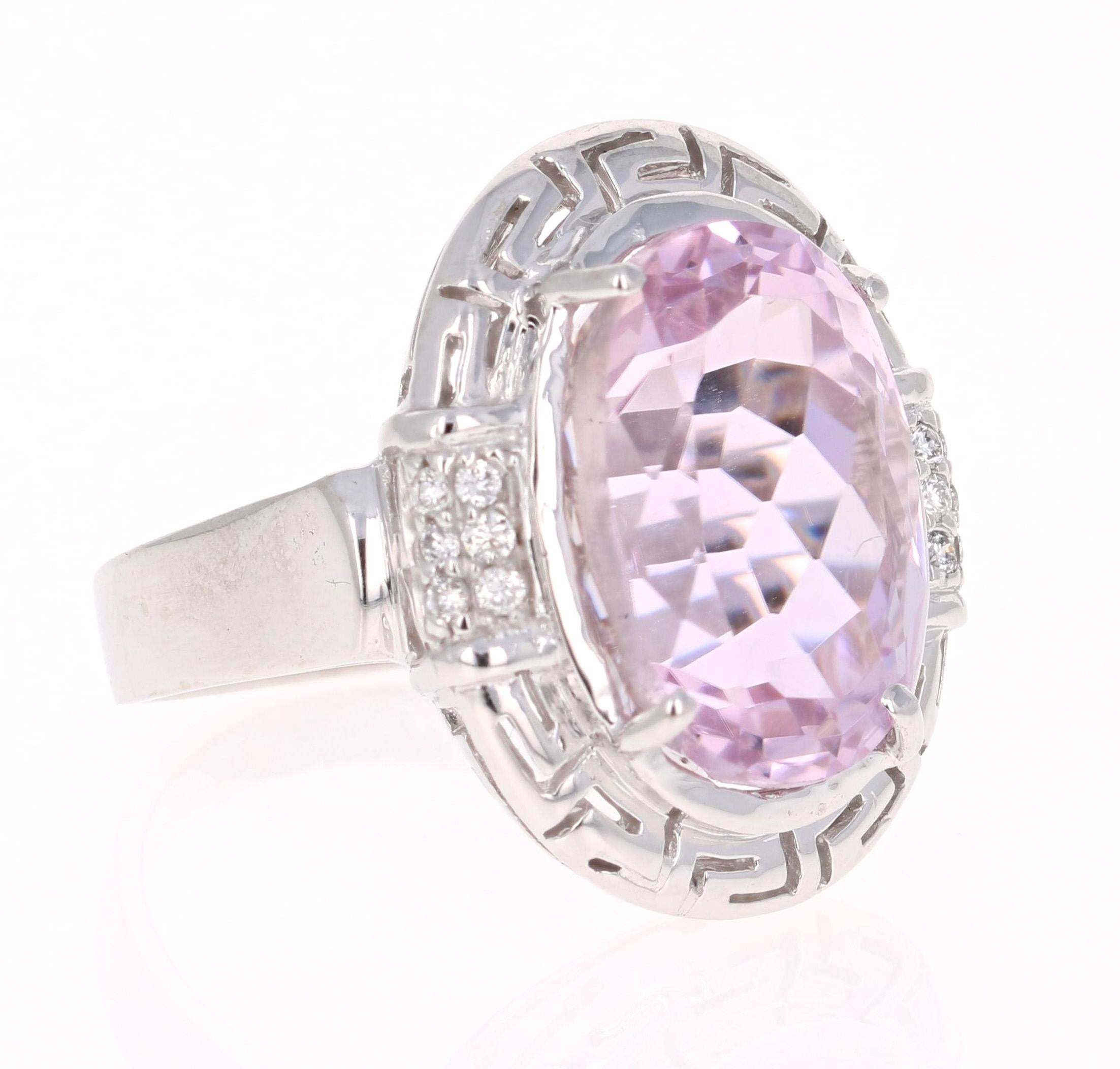 This stunning Art Deco - Inspired ring has a large 12.09 Carat Kunzite and is surrounded by 14 Round Cut Diamonds that weigh 0.14 carats.  The total carat weight of the ring is 12.23 carats. The design of this ring is so unique and totally art-deco