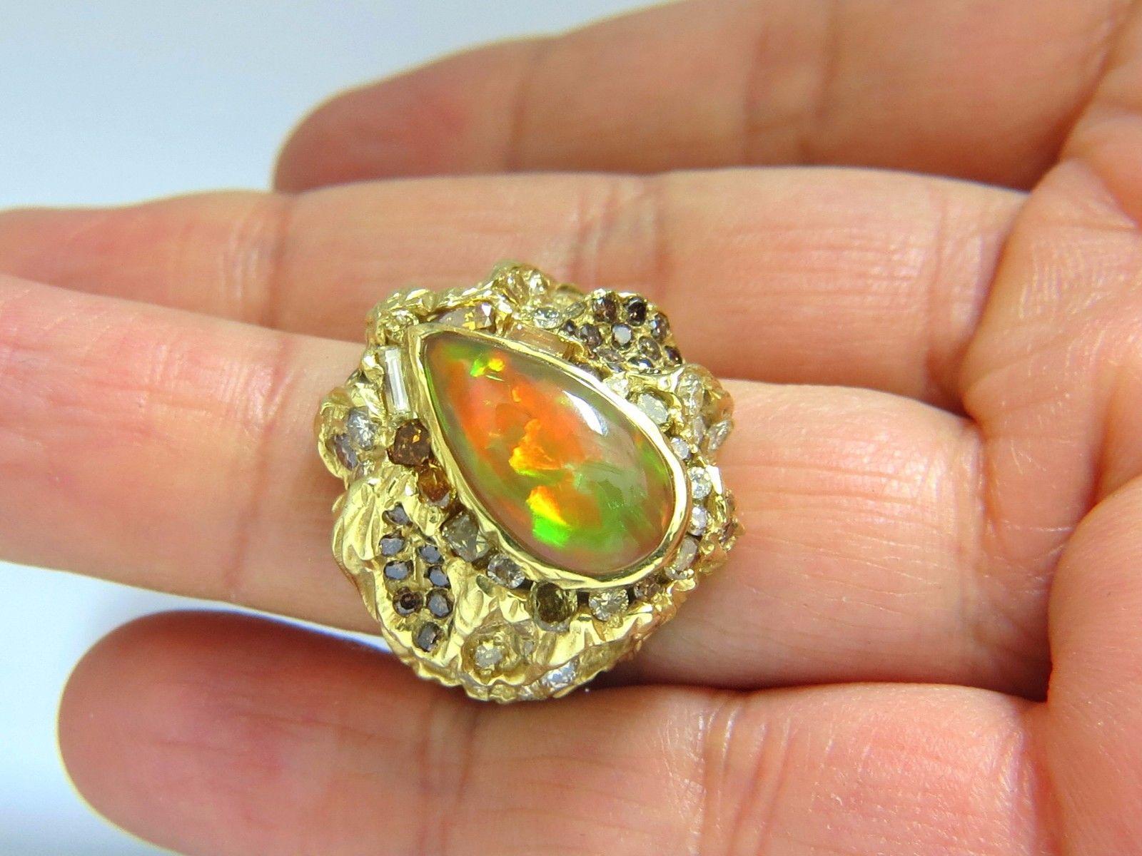 6.00CT Natural Opal Ring.

Cabochon Pear Shaped

VS clean clarity

Brilliant rays of orange, greens and some reds.

A true holographic effect

Opal is NOT a dublet

17 X 8 mm



6.25ct. diamonds

Rounds and full cuts.

Mix of natural fancy browns