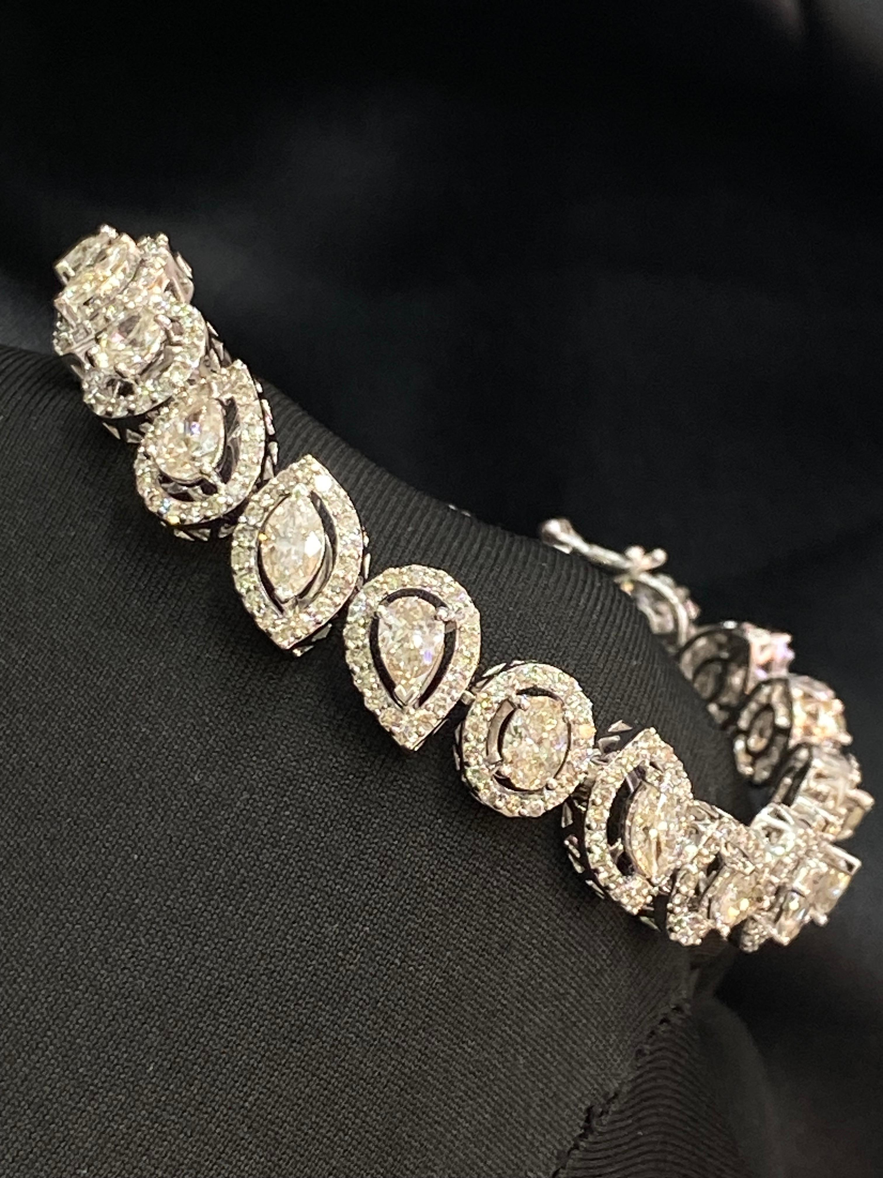 This exquisite bracelet showcases a total of 12.28 carats of pear, marquise, oval, heart, and round-shaped diamonds. Among them are 21 pieces of single pointers totaling 6.30 carats (each diamond weighing 0.30 carats), alongside 5.98 carats of side