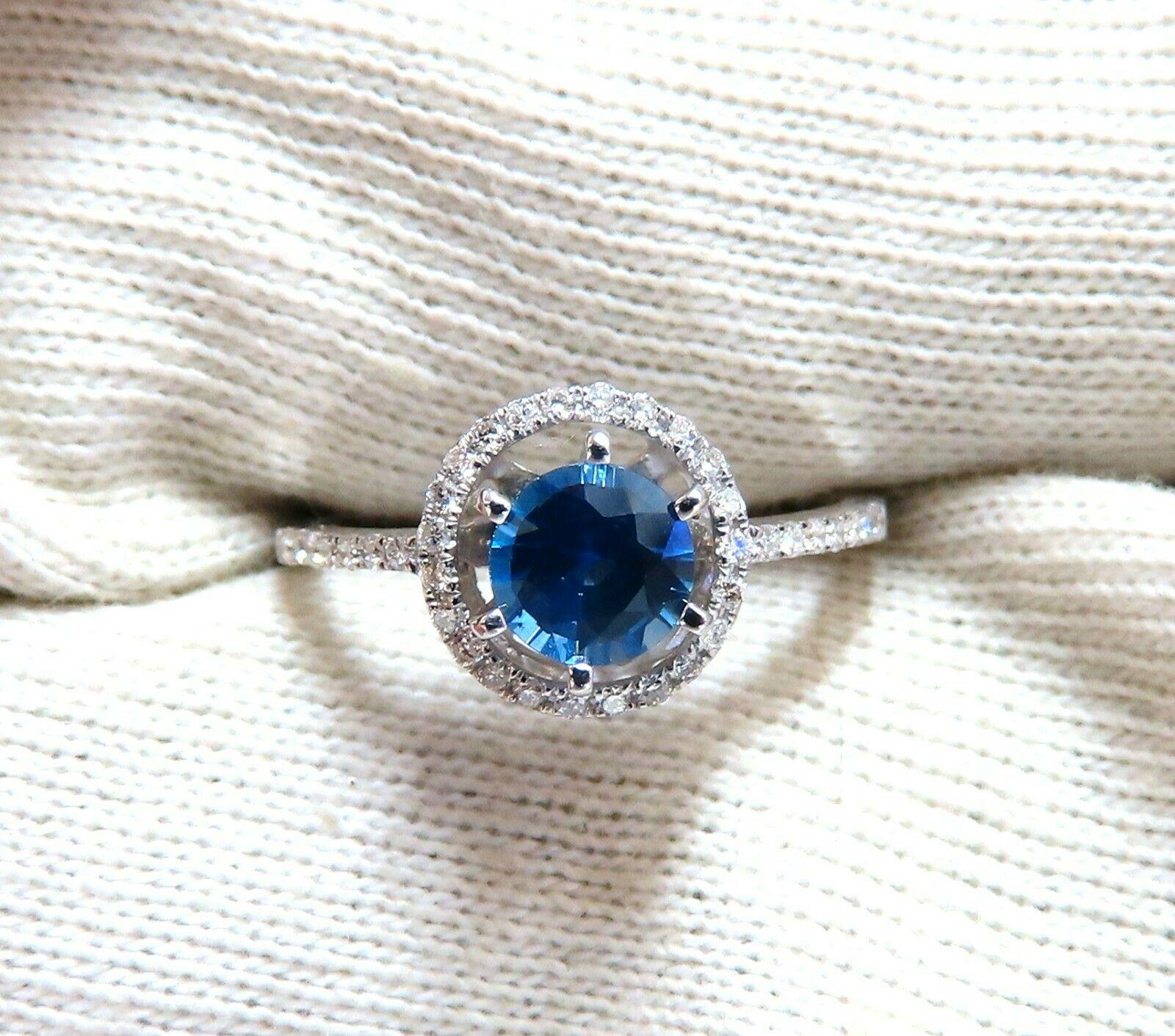 Raised halo Blue.

.82ct Natural Round cut sapphire ring.

Vivid Royal Blue

Clean Clarity & Transparent.

5.6mm

.40ct Natural Side round diamonds.

H-color Vs-2 clarity.

14kt. white gold

2.6 grams

Ring Current size: 7

depth of ring: