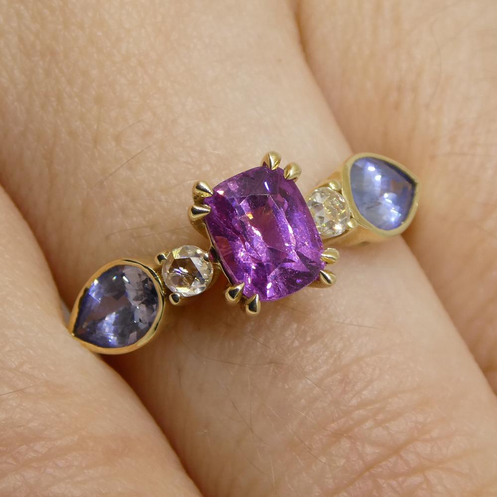 This is a stunning Sapphire Ring, set with a gorgeous Pink-Purple Sapphire with Blue Sapphire and diamond side stones in an 14kt yellow gold setting. 

Gem Type: Sapphire
Number of Stones: 1
Weight: 1.22 cts
Measurements: 6.45 x 5.29 x 4.07