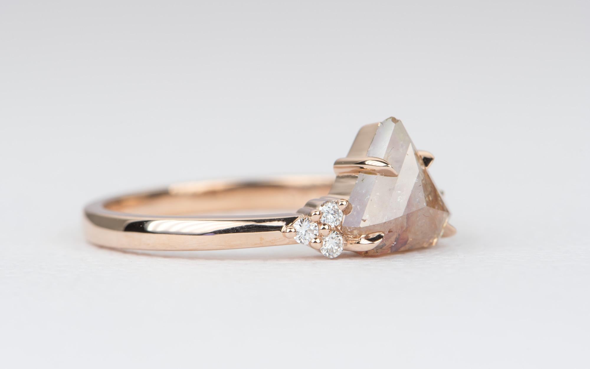 ♥  Solid 14K rose gold ring with a reddish-coral color center diamond in the center
♥  A trio of diamonds accent the center diamond on each side
♥  The overall setting measures 13.16mm in width, 7.60mm in length, and sits 5.03mm tall from the