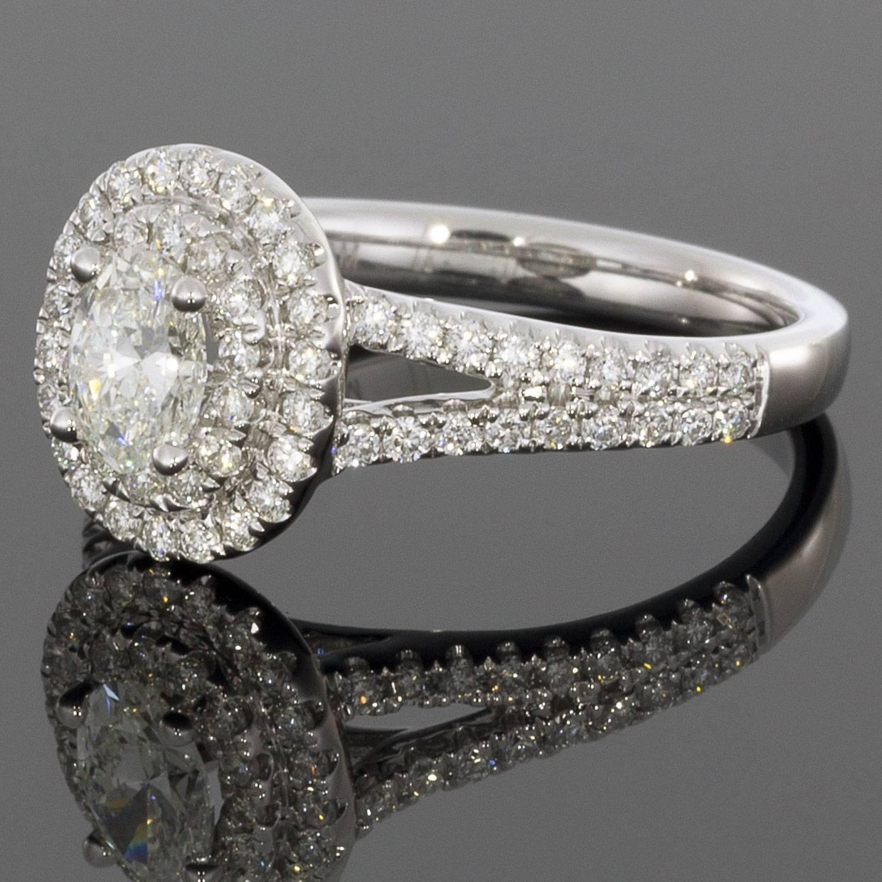 The double halo surrounding this oval diamond makes this diamond engagement ring stand out. The center diamond is H/SI2 and weighs .38 carats. 

DETAILS:
1.22CTW Diamond Engagement Ring
.38CT oval H/SI2 center diamond
.84CTW white round accent