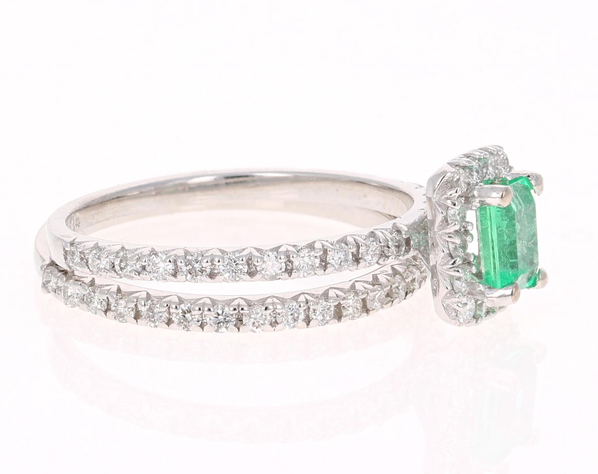 A simple setting with a wedding band holding a beautiful natural Emerald that weighs 0.48 Carats surrounded by 61 Round Cut Diamonds weighing 0.75 Carats. 

The Emerald measures at 5.5 mm x 4.5 mm and the face of the ring measures at approximately