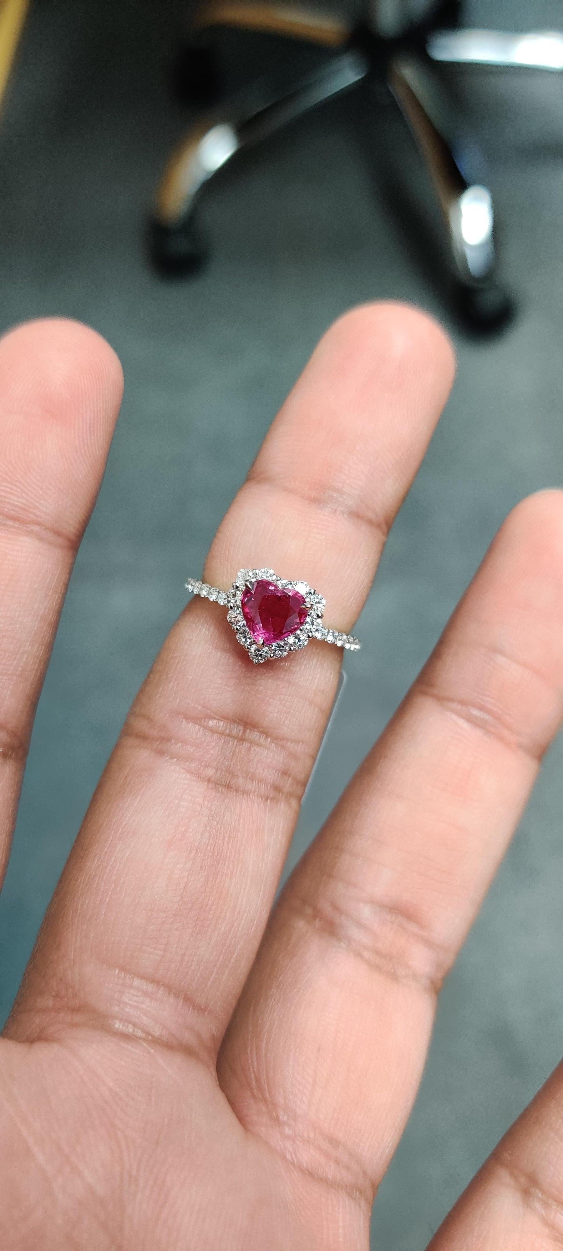 Introducing our breathtaking Heart-Shaped Ruby Ring, a true testament to love and elegance. This exquisite piece features a dazzling 1.23 carat heart-shaped ruby, symbolizing passion and romance, surrounded by 0.54 carats of shimmering diamonds,