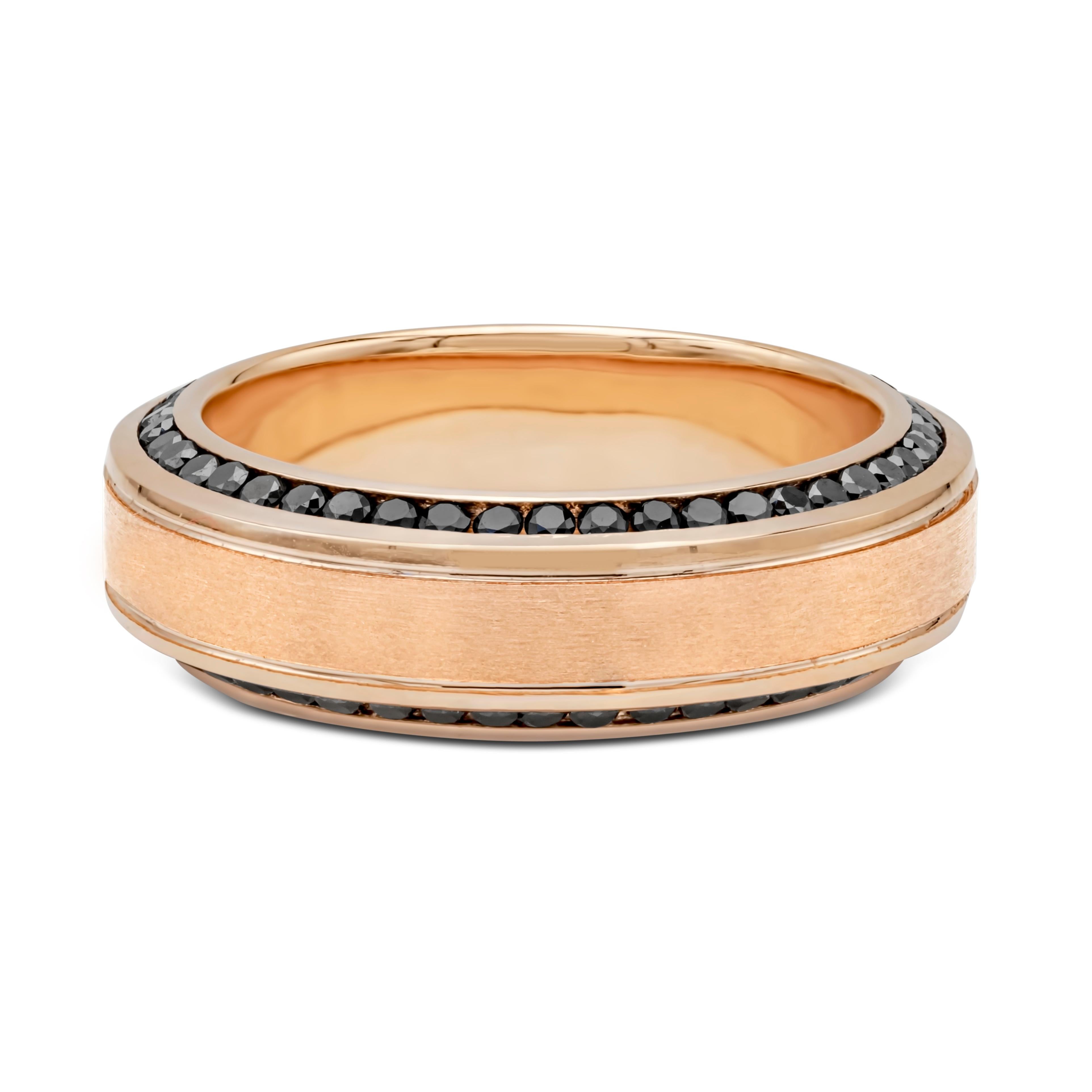 A comfort fit wedding band wrapped with black diamonds weighing 1.32 carats total; channel set on each side of the ring. Two lines finely-engraved in the middle portion of the ring and made in 18k rose gold. Gorgeous brushed inlay finish. Size 10