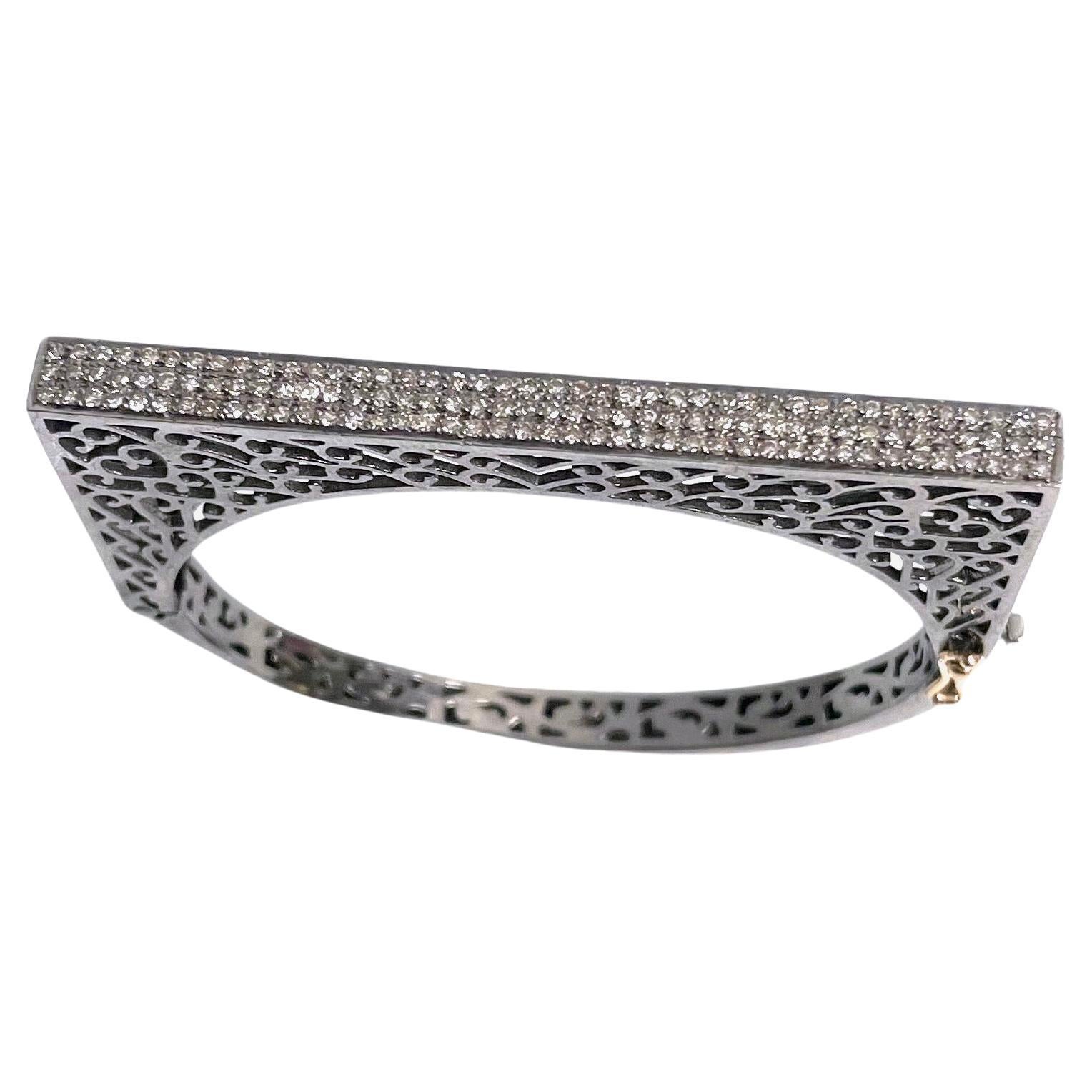 Description
This chic and unique statement bracelet, artfully designed and exquisitely crafted with intricate latticework holds three rows of sparkling diamonds adorning the top and sides. With its sleek and contemporary design, this piece features