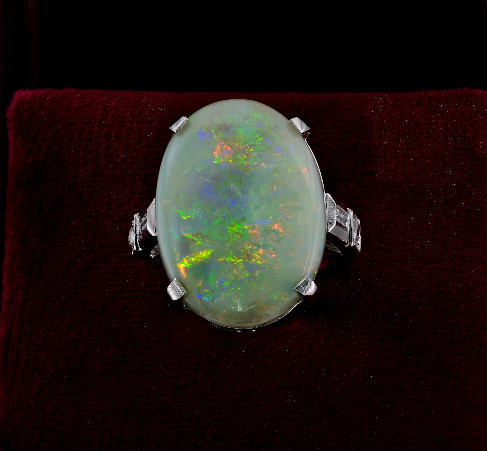 Impressive Opal and Diamond ring, 1960 ca
Exquisitely hand crafted of solid 18 KT white gold in a classy solitaire design with Diamond complement on shoulders
The large Natural solid Australian Opal displays a Kaleidoscope of colours of green, pink,