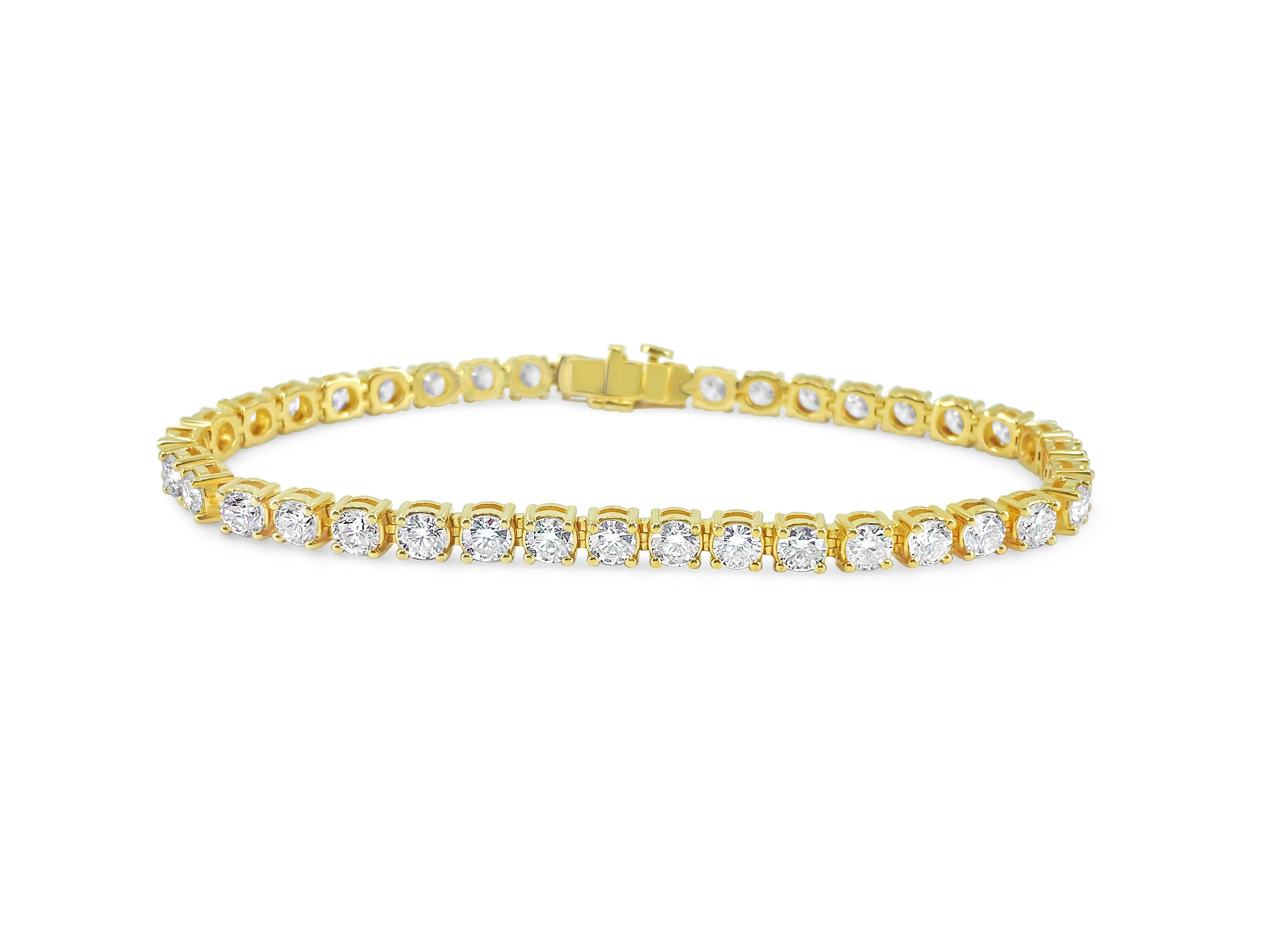 Elegance meets extravagance in this stunning 14k yellow gold diamond tennis bracelet, featuring 12.33 carats of dazzling round brilliant cut diamonds with VS clarity and G color. A masterpiece of natural earth-mined diamonds, this beautiful unisex