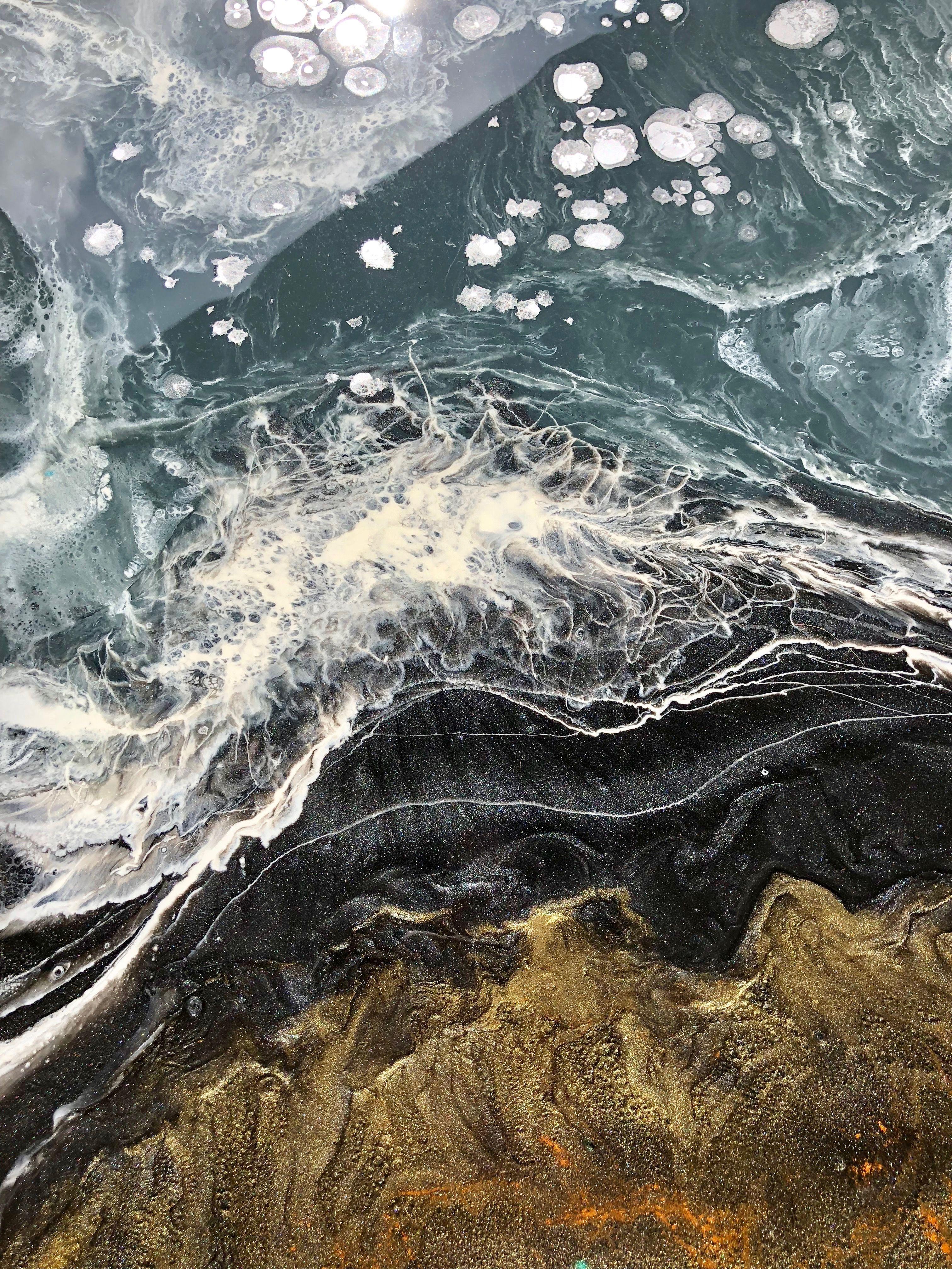 After getting a gorgeous gander at the Alaskan shoreline from the plane, I was inspired to make an abstract resin pour painting with that color scheme. Cold blue-grey waves wash up against coarse black sands with foaming tips and speckles of seafoam