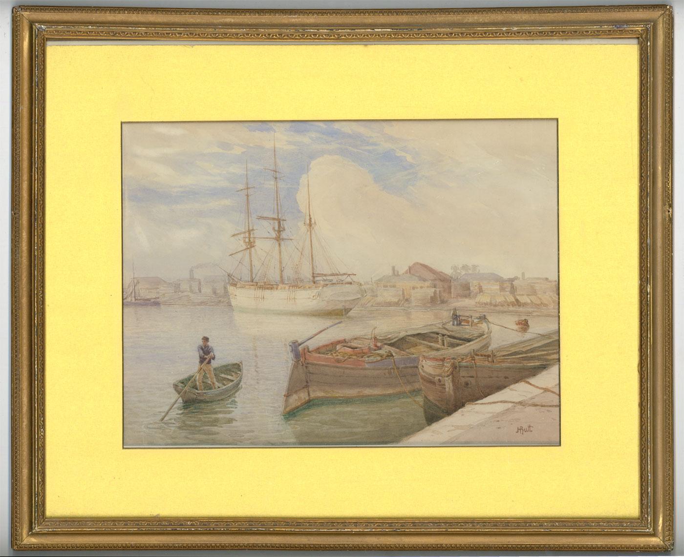 A fine English School watercolour depicting a dock scene with harboured boats and a man standing in a little rowboat. Presented in a gilt mount and gilt frame. Signed. On wove.
