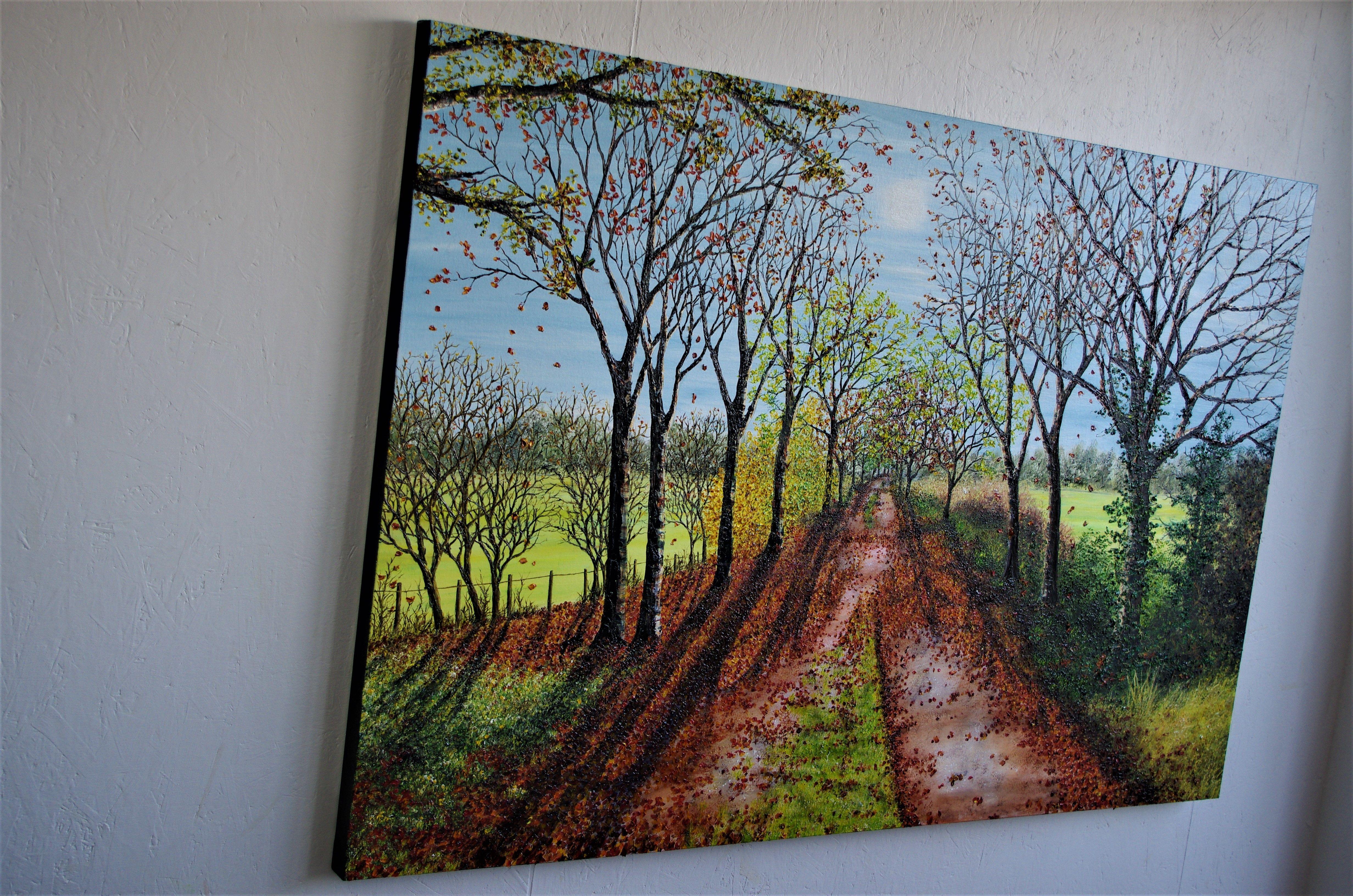 Una pintura con textura, de  Hermoso paseo por un camino arbolado, que hace muchos años era una línea de ferrocarril que atravesaba el campo y que ahora la naturaleza ha recuperado. Esta escena es de otoño, con las hojas cayendo lentamente con una