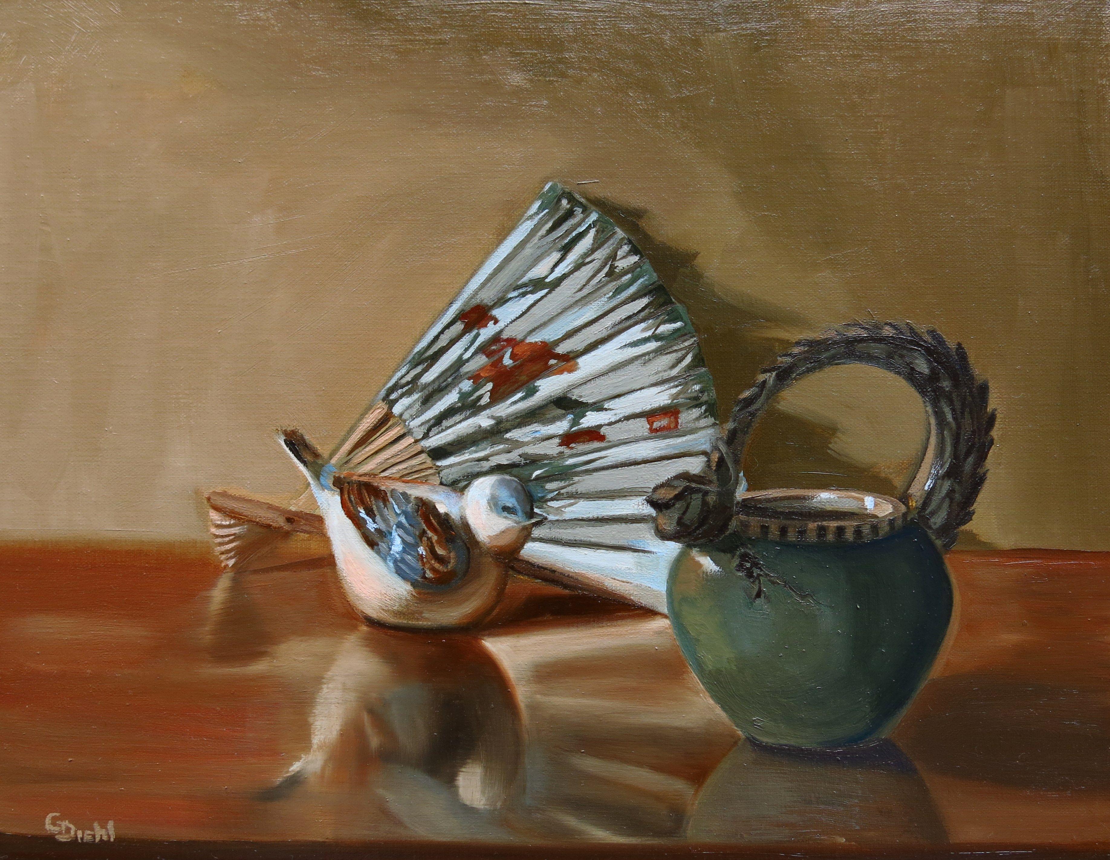 An oriental theme was implied in this composition. The petite pot with the dragon handle, a rose motif colored fan all support this. The porcelain bird's colors tie in with the palate scheme. From the positioned studio lamp, subjects' forms are