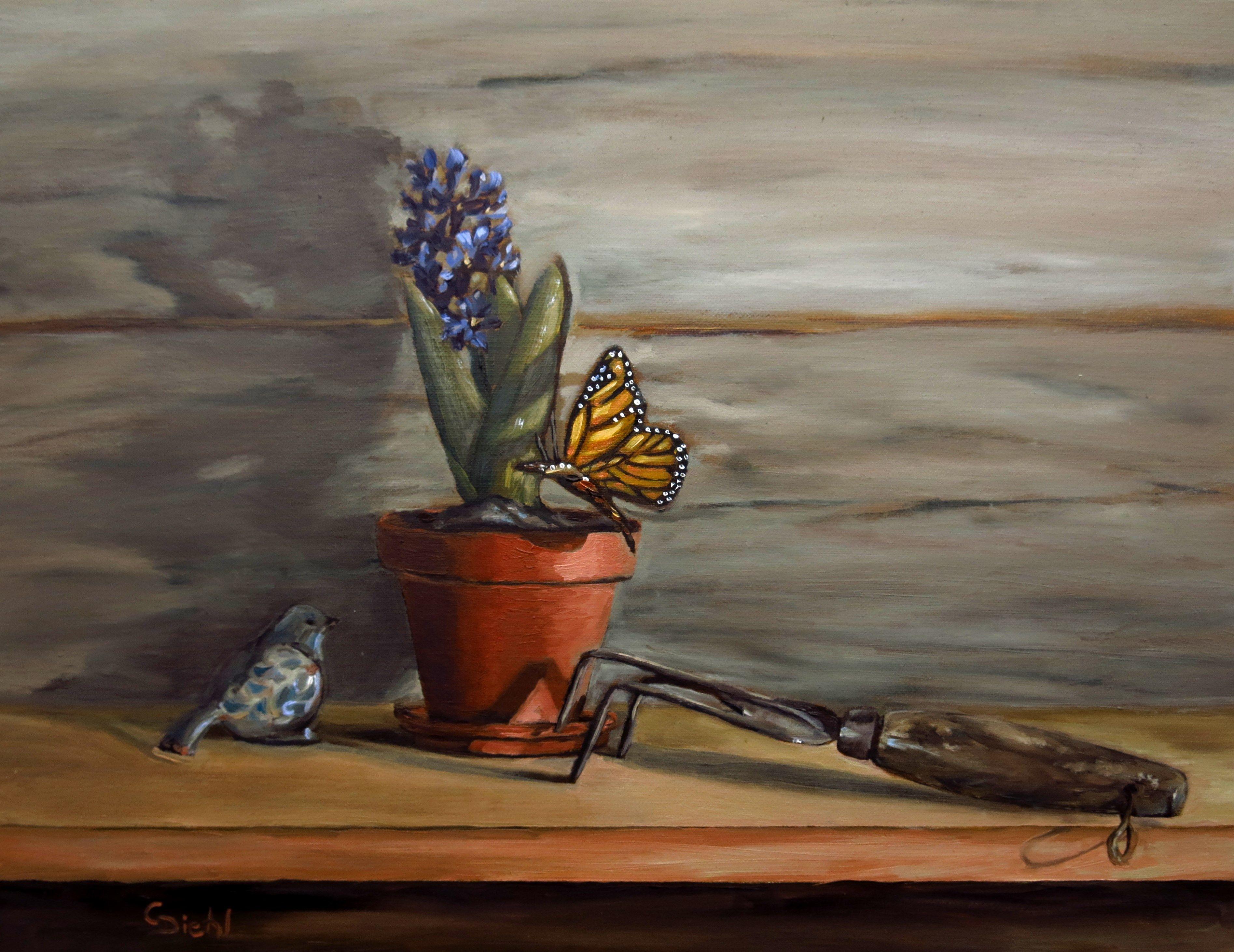 Gardening is the theme in this unique, original oil painting. A potted floral lilac, a ceramic bird, a butterfly and a gardening tool are objects featured in this still life artwork. This fine artwork has been created in oils on a 11"x14" support.