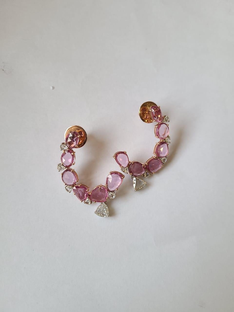A very dainty and beautiful pair of Pink Sapphire Chandelier / Hoop Earrings set in 18K Rose Gold & Diamonds. The weight of the Pink Sapphires is 12.34 carats. The Pink Sapphires Rose Cuts are sourced from Madagascar. The weight of the Diamond Rose