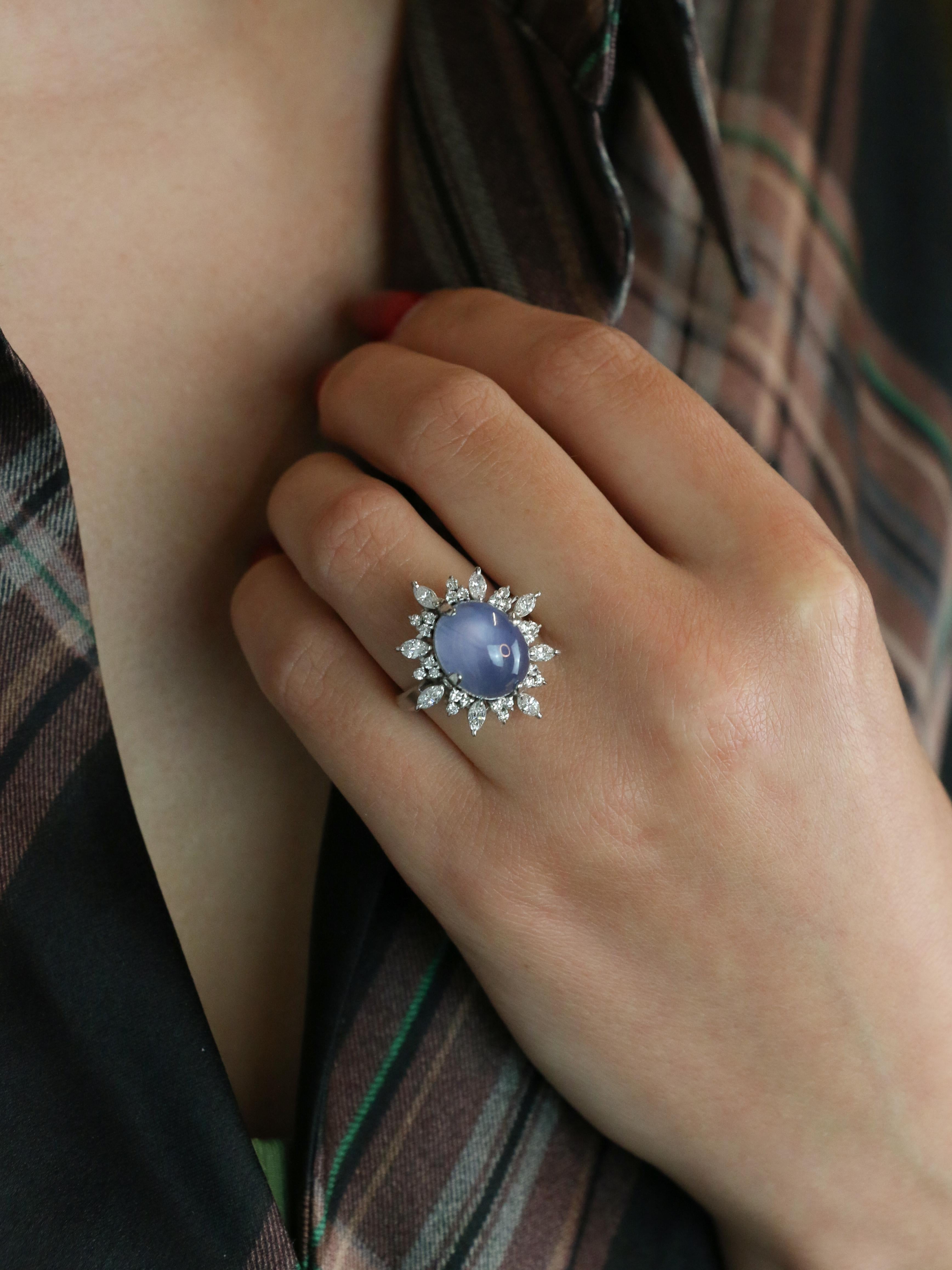 Star sapphire and diamond platinum ring

Platinum ring set with a central cabochon unheated Ceylon lavender star sapphire weighing approximately 12.34 carats (13.01 x 10.24 x 8.58) surrounded by high-quality marquise-cut and brilliant-cut diamonds