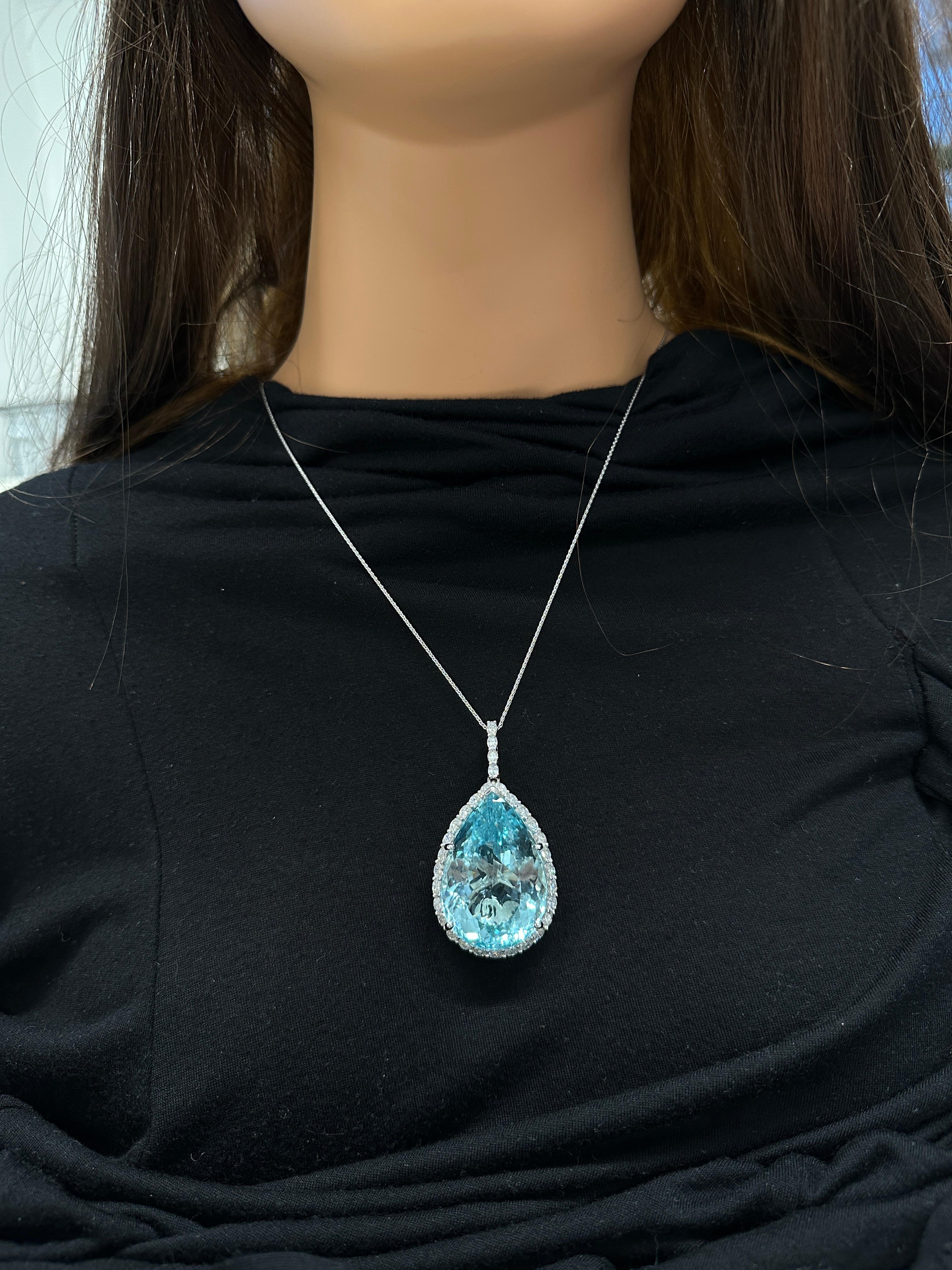 Reminiscent of a bright blue sky, this is a gorgeous Swiss blue topaz Pendant. A 123.44 carat Oval fantasy cut Swiss blue topaz is prong set and skillfully cut with a starburst pavilion. Swiss blue topaz is known for its intense blue shade with
