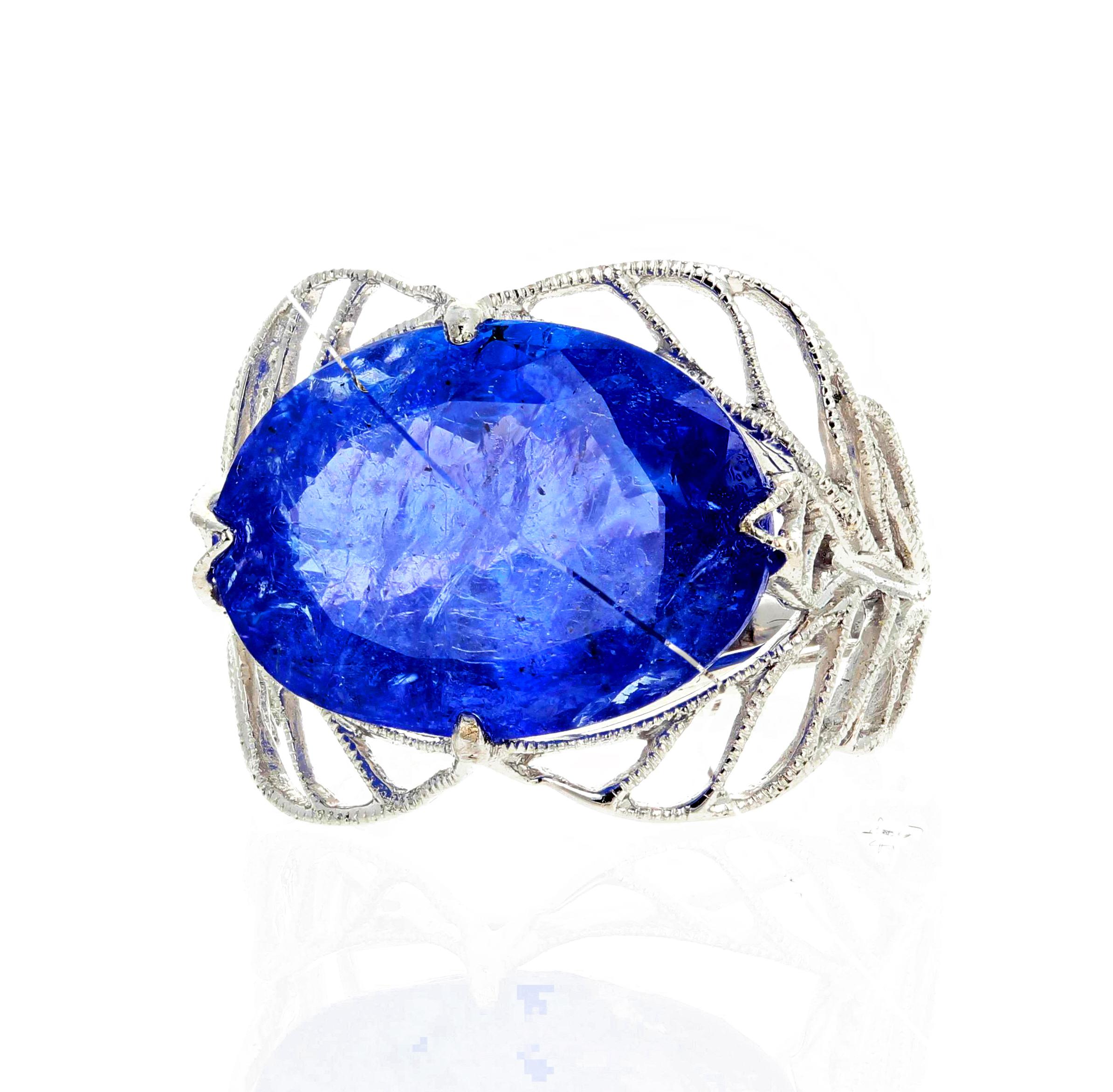 Big natural blue 12.35 Carat oval cut Tanzanite set in an elegant white gold ring size 7 (sizable).  This natural Tanzanite is approximately 17 mm x 13 mm.  There are no eye visible inclusions in this beautiful gemstone. 