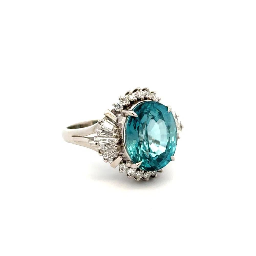 Simply Beautiful! Finely detailed Oval Blue Zircon and Diamond Platinum Vintage Cocktail Ring. Centering a securely nestled Hand set Oval Blue Zircon, weighing approx. 12.36 Carat. Surrounded by Round Brilliant Cut Diamonds, approx. 0.95tcw. Hand
